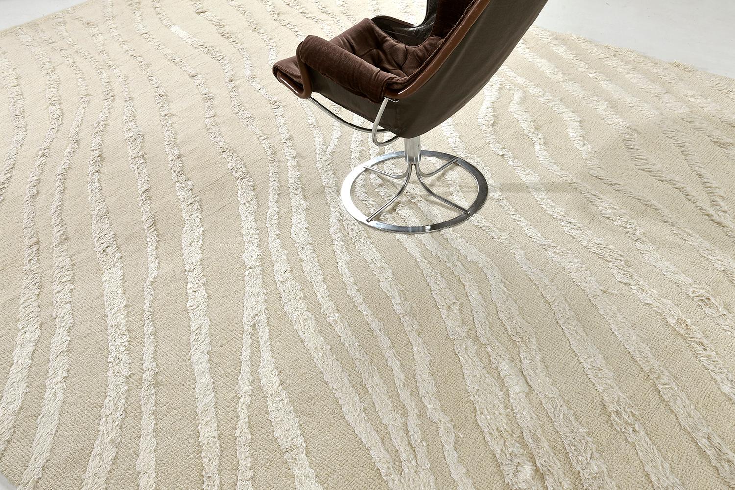 The deeply contrasting and luxurious wool rug with silk embossed detailing features prominently in the beauty of 'Profile'. The surface is ever changing. A brushing turns the direction of the fibers. The silk pile is lustrous, refracting light in