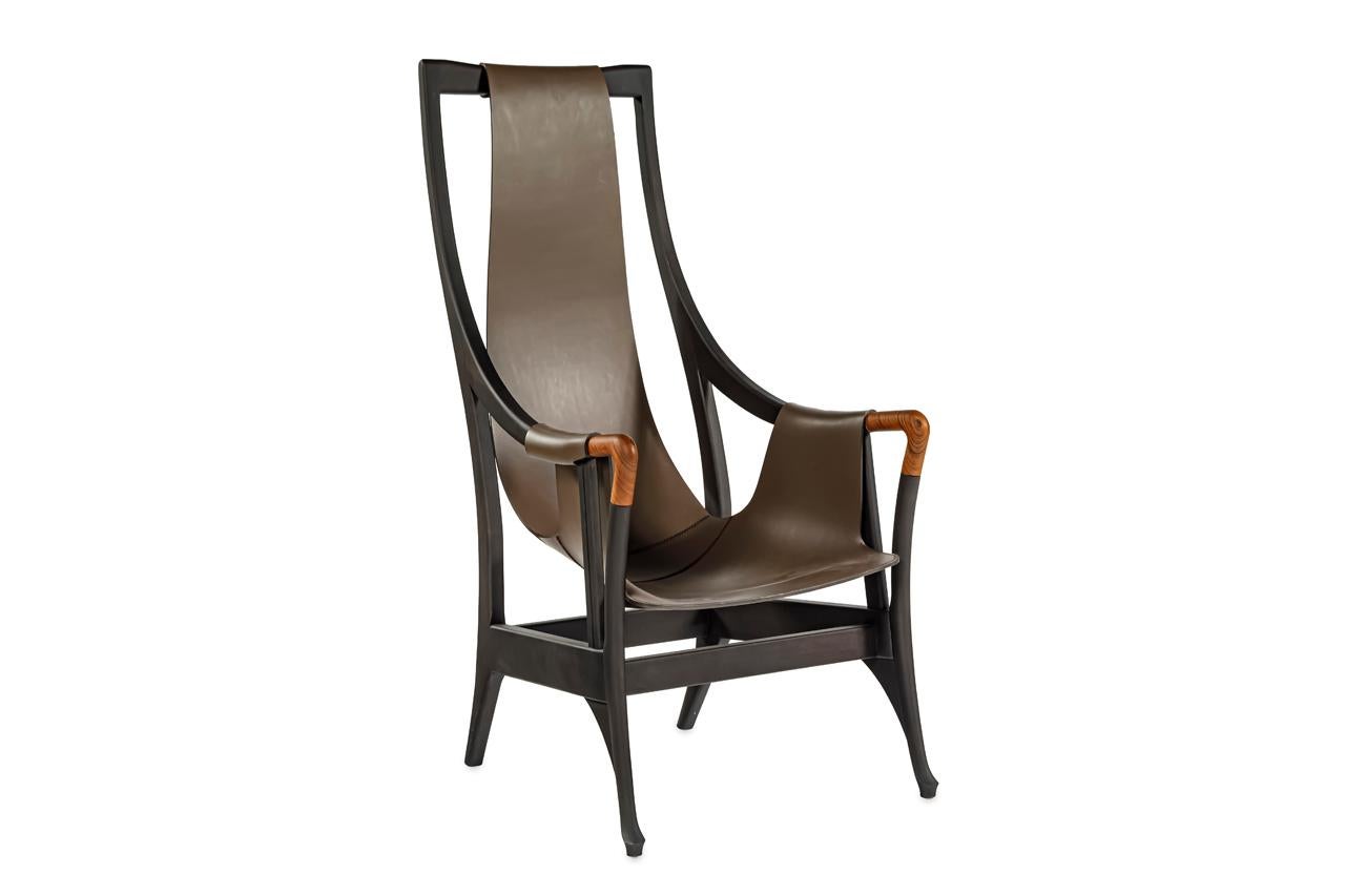 Armchair with a wooden structure and a tan saddlehide seat