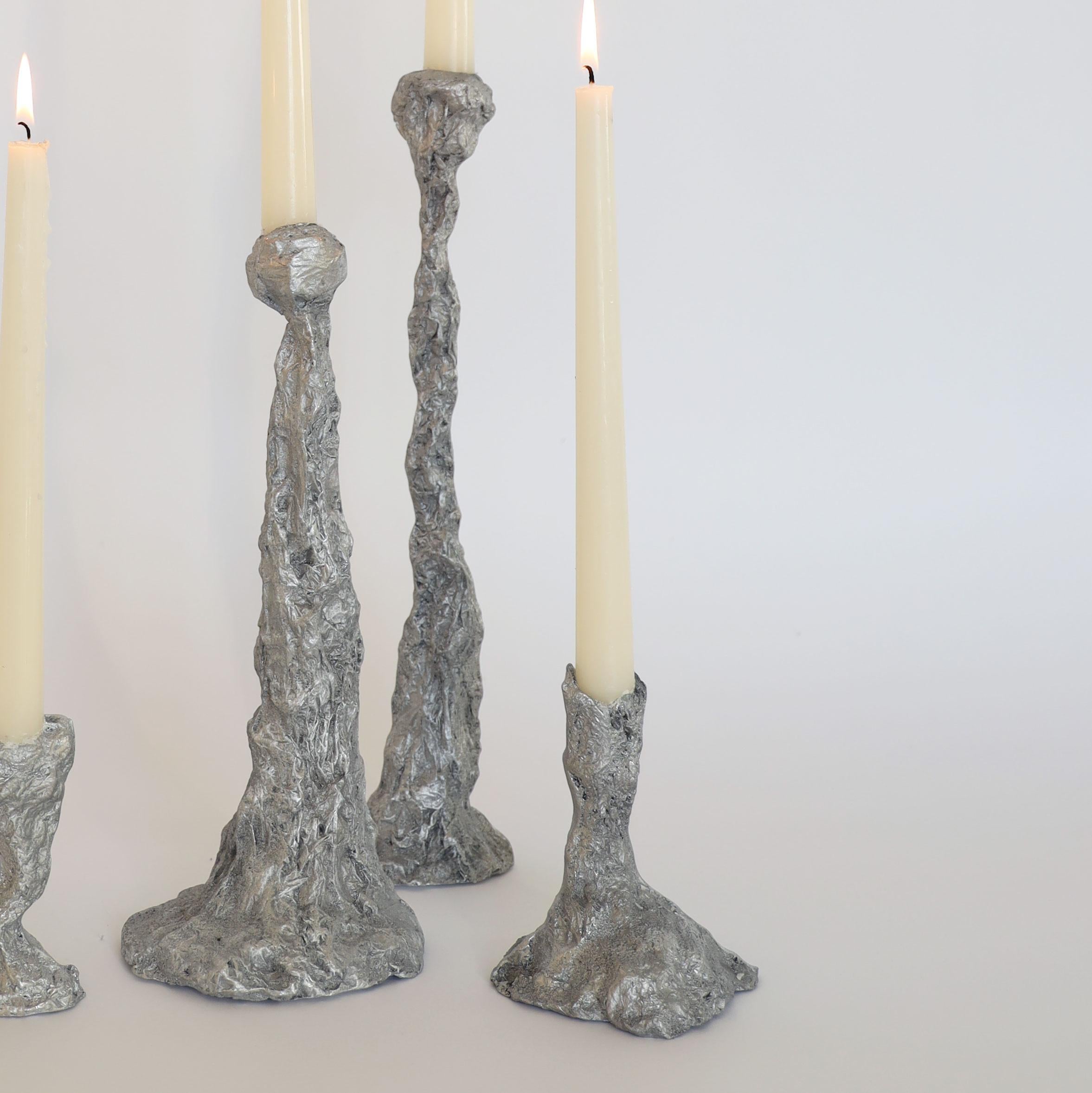 We sculpt each candlestick with aluminum foil before sand-casting it in aluminum at our local foundry. It’s a physical ‘game of telephone’, a translation, or a conversation, or maybe a pun. 

A humble-but-striking, utilitarian-but-elegant, perfectly