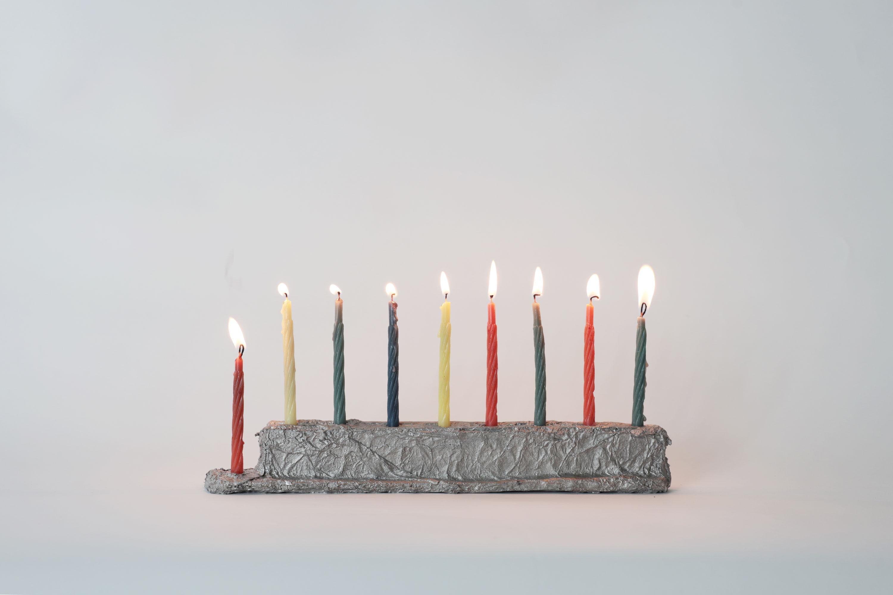 We sculpt each Menorah with aluminum foil before sand-casting it in aluminum at our local foundry. It’s a physical ‘game of telephone’, a translation, or a conversation, or maybe a pun. 

A humble-but-striking, utilitarian-but-elegant, perfectly