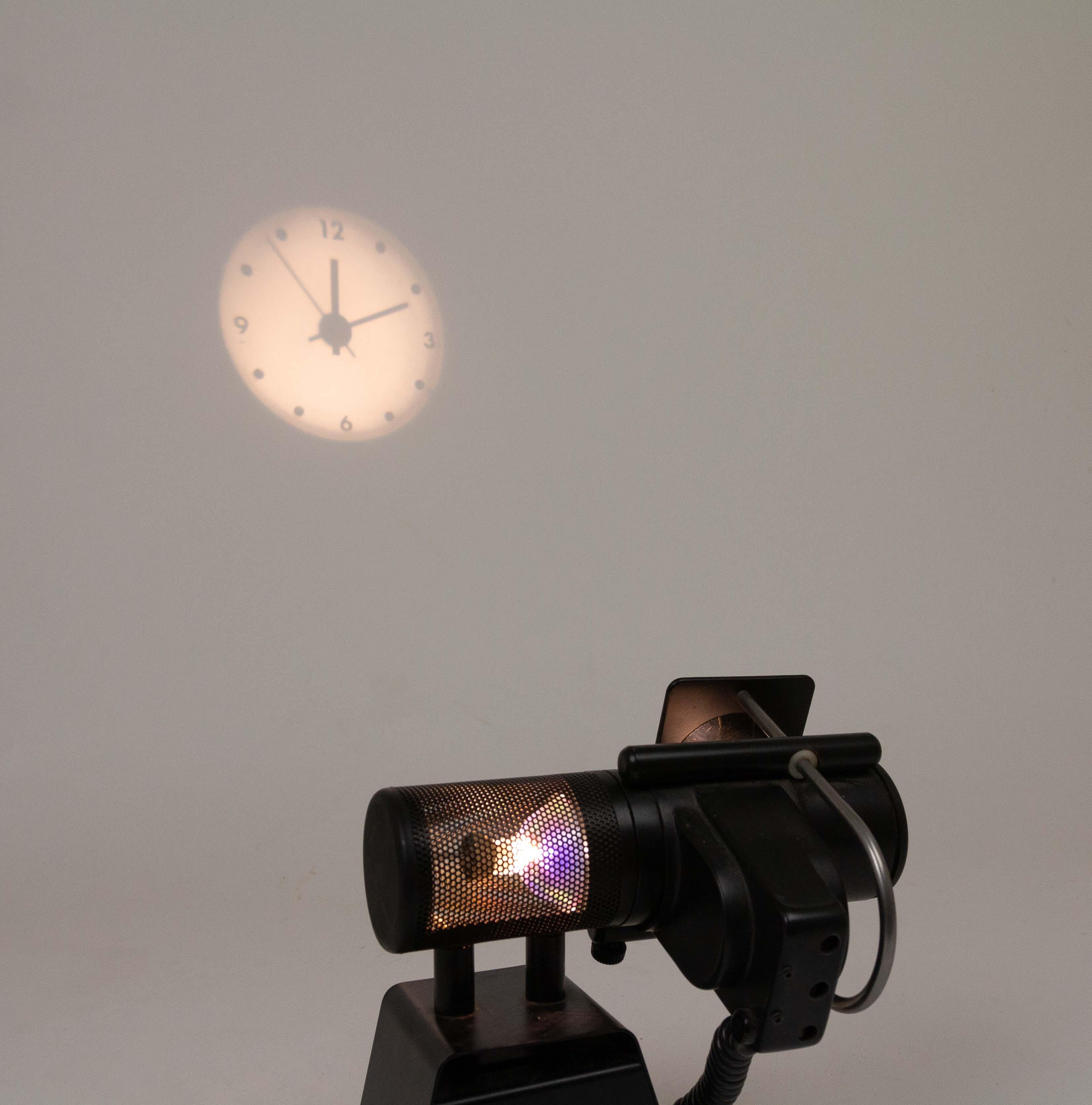 Projection clock designed in 1985 by Stephen Savage and produced by Timebeam, a British company founded by Stephen and Anthea Savage.

In the 1980s the idea to project the clock image by means of a lens was new and innovative. In our time it is