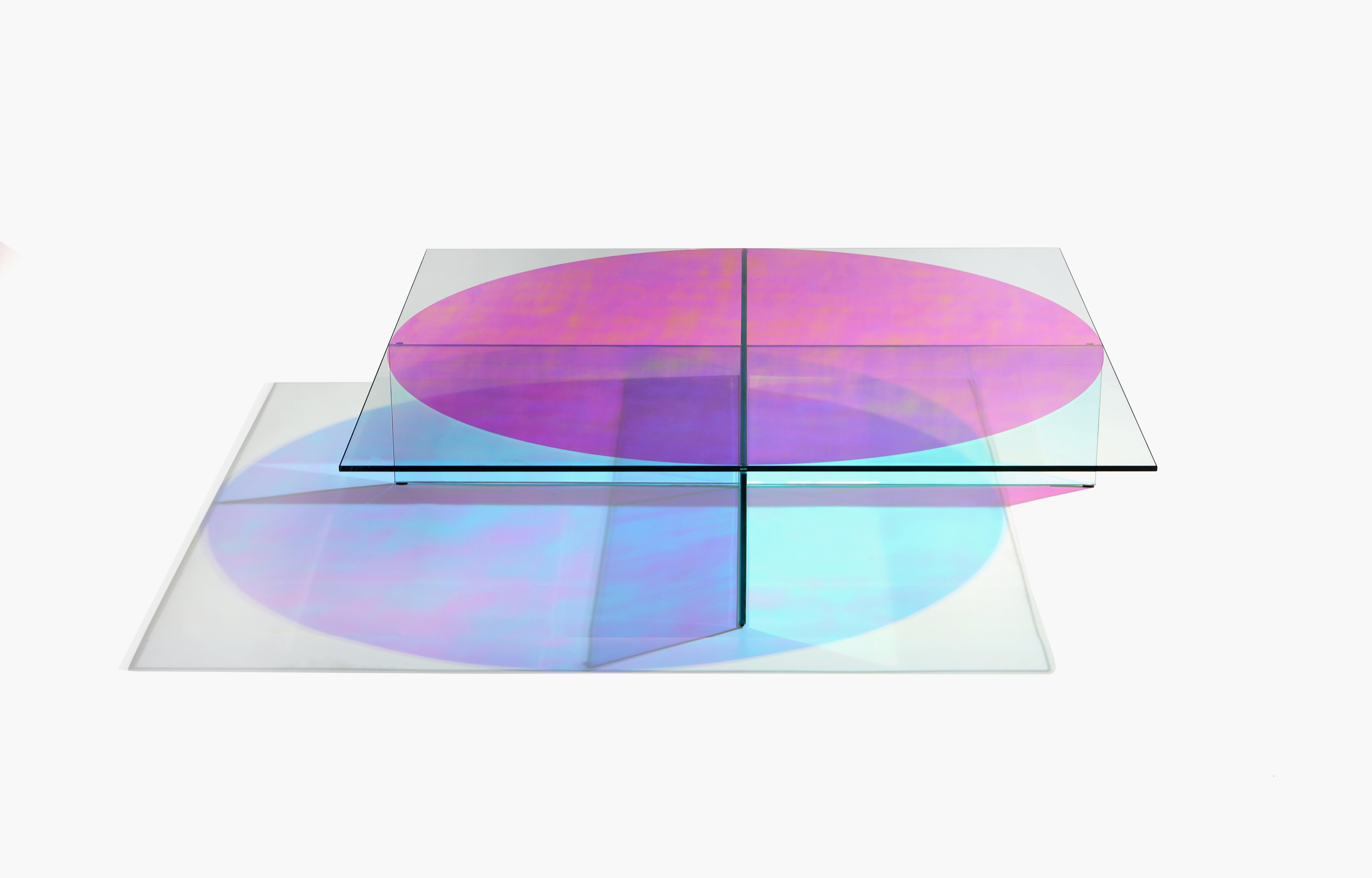 glass coffee table with iridescent circular film on the top