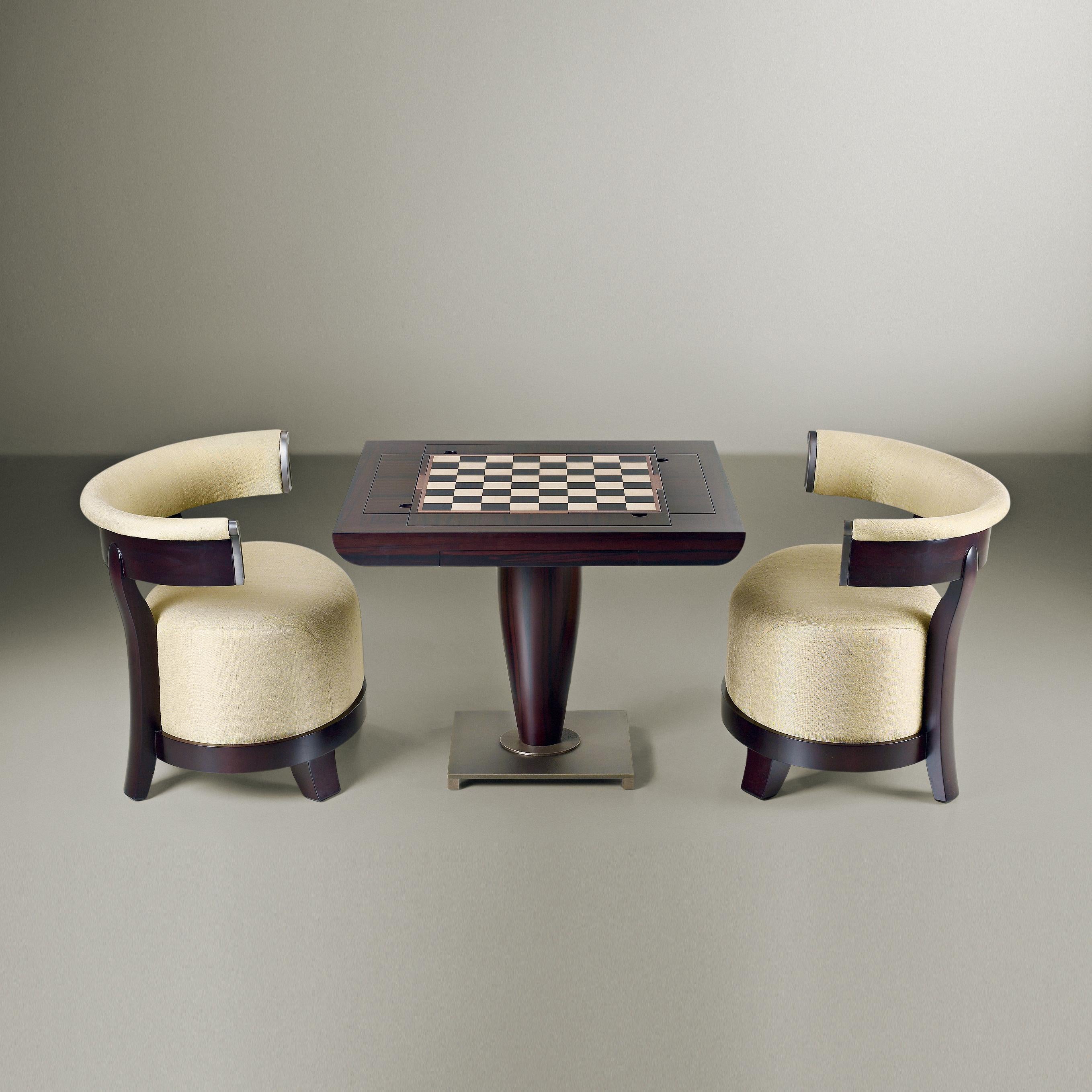 Bassano da Gioco game table is part of a large family of tables, Promemoria's bestsellers, which is characterized by a shaped and curved column which supports the table top as a work of architecture with solid foundations. The base is in bronze.