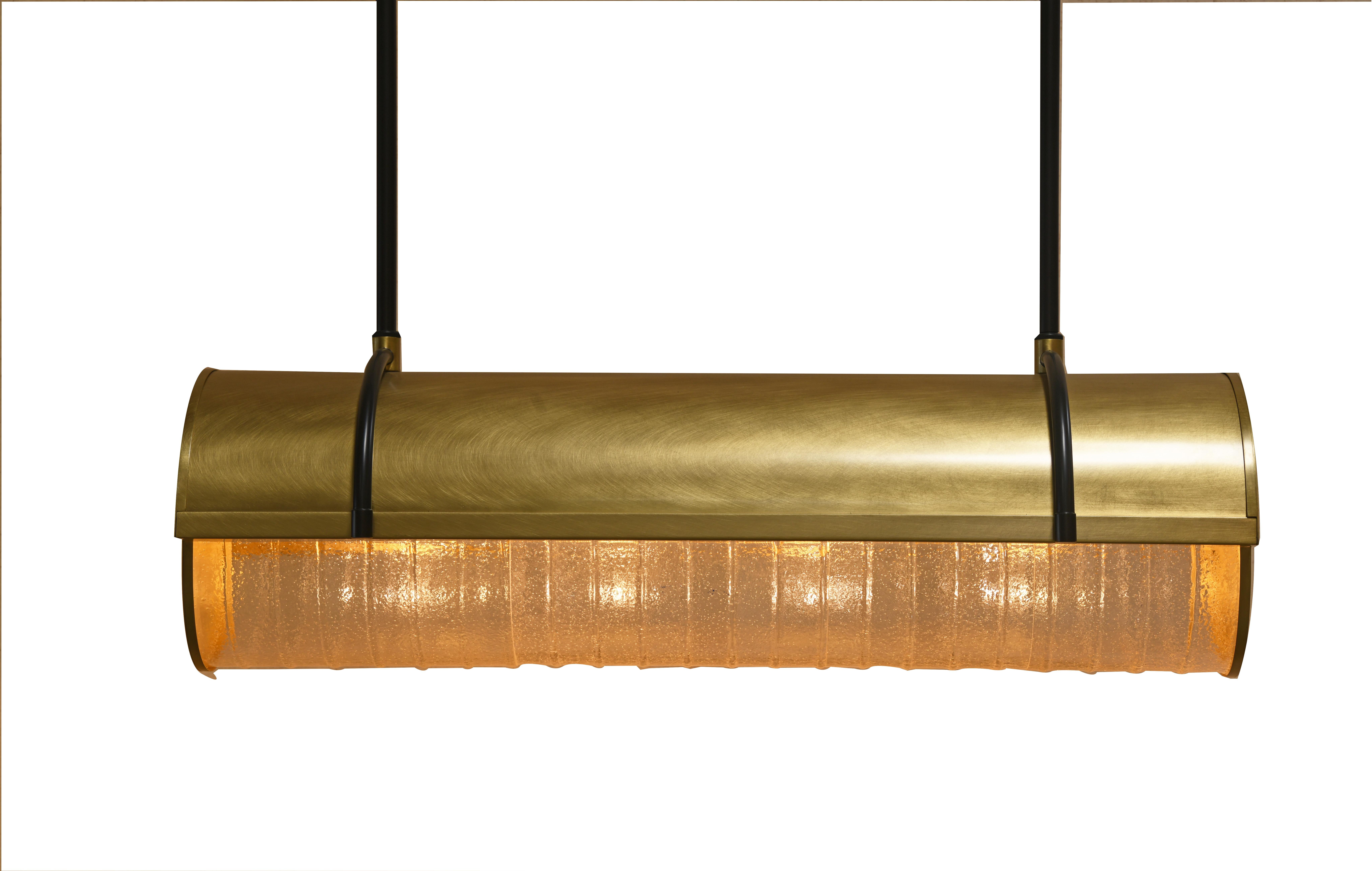 Bands of cast-seeded glass smolder shoulder to shoulder in a curve of burnished brushed brass with bold blackened brass suspension.

Models in the collection are individually hand-crafted by the skilled artisans in our studio. Custom versions