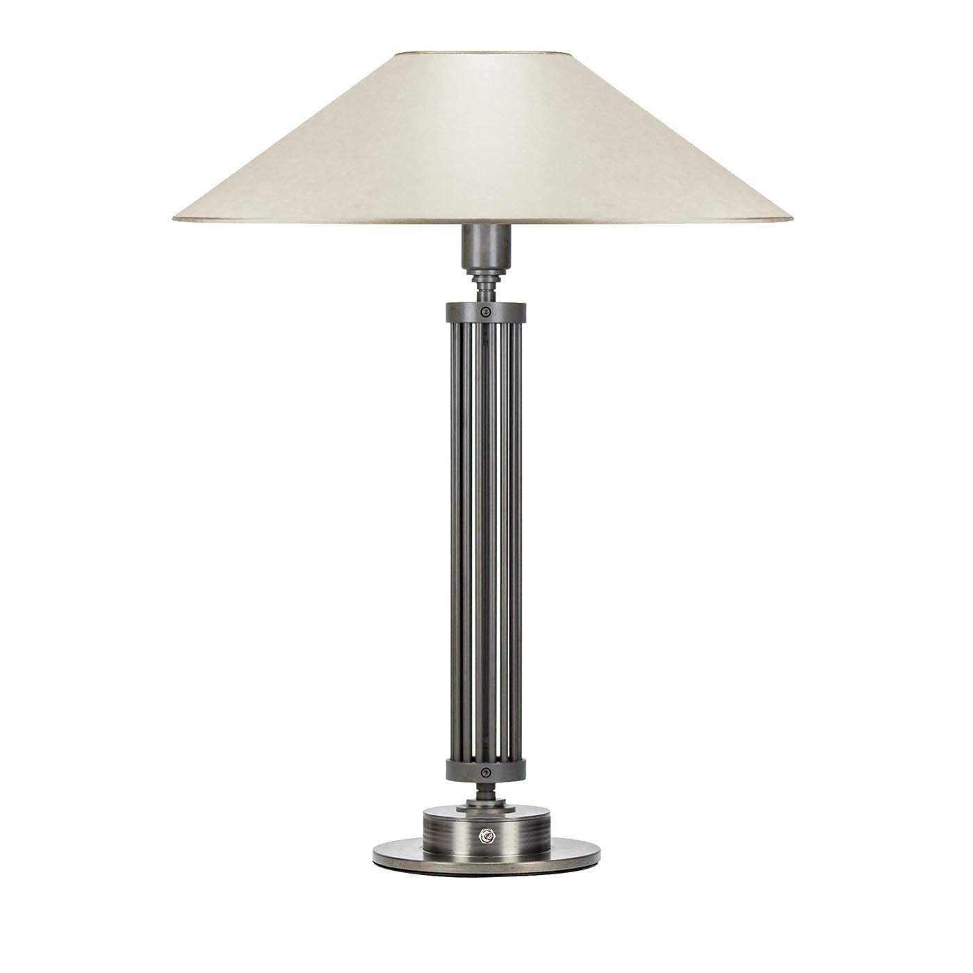 With an attention to detail that goes beyond functionality, this table lamp merges classic lines with a modern sensibility in a silhouette that will look equally stunning in a contemporary and traditional decor. The linear structure is handcrafted