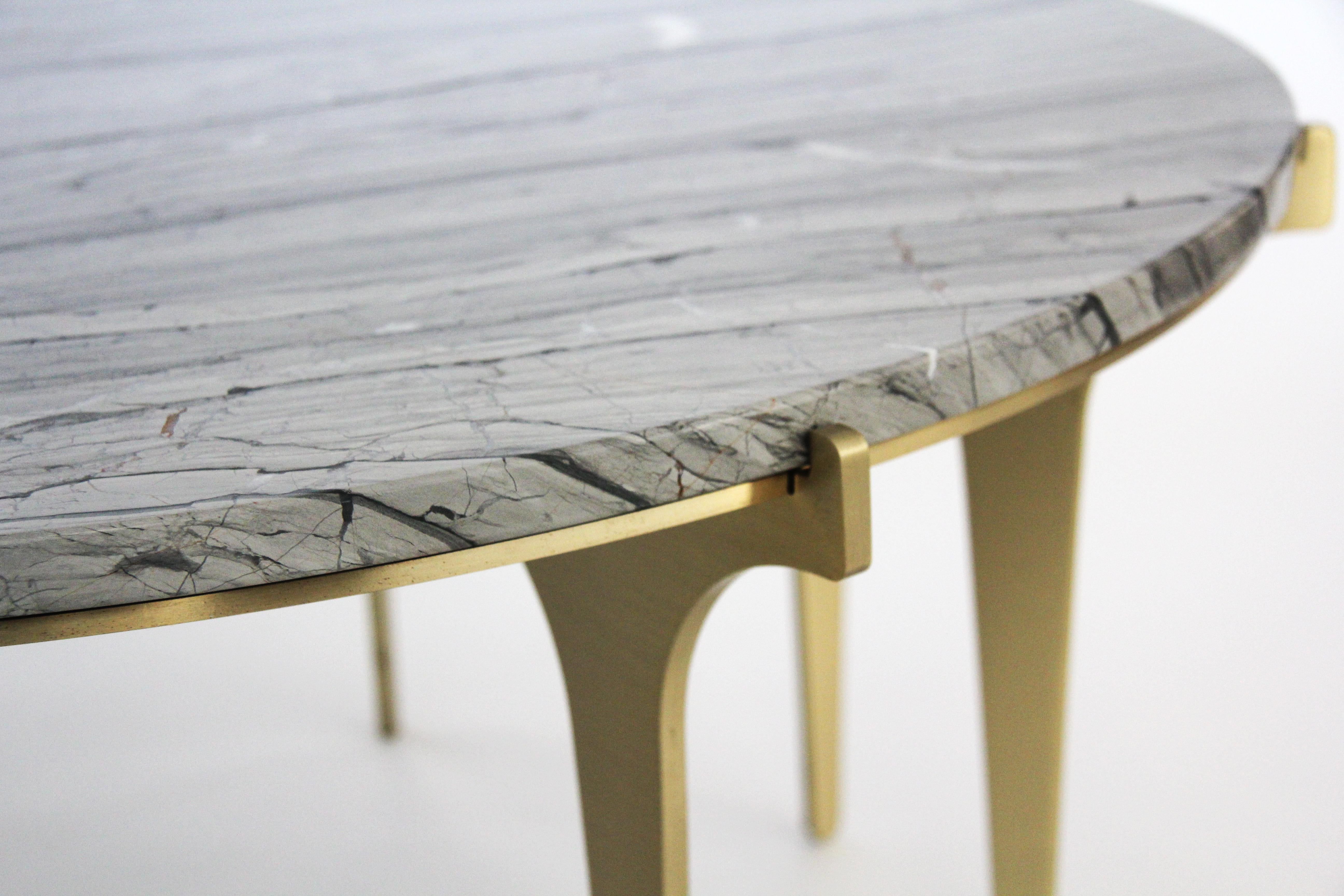 With the same lightweight feel found throughout the PRONG series, this marble coffee table floating atop tall legs is available in blackened steel, satin brass, satin copper, or satin nickel with Grigio Carnico (black), Onda Argento (silver), and