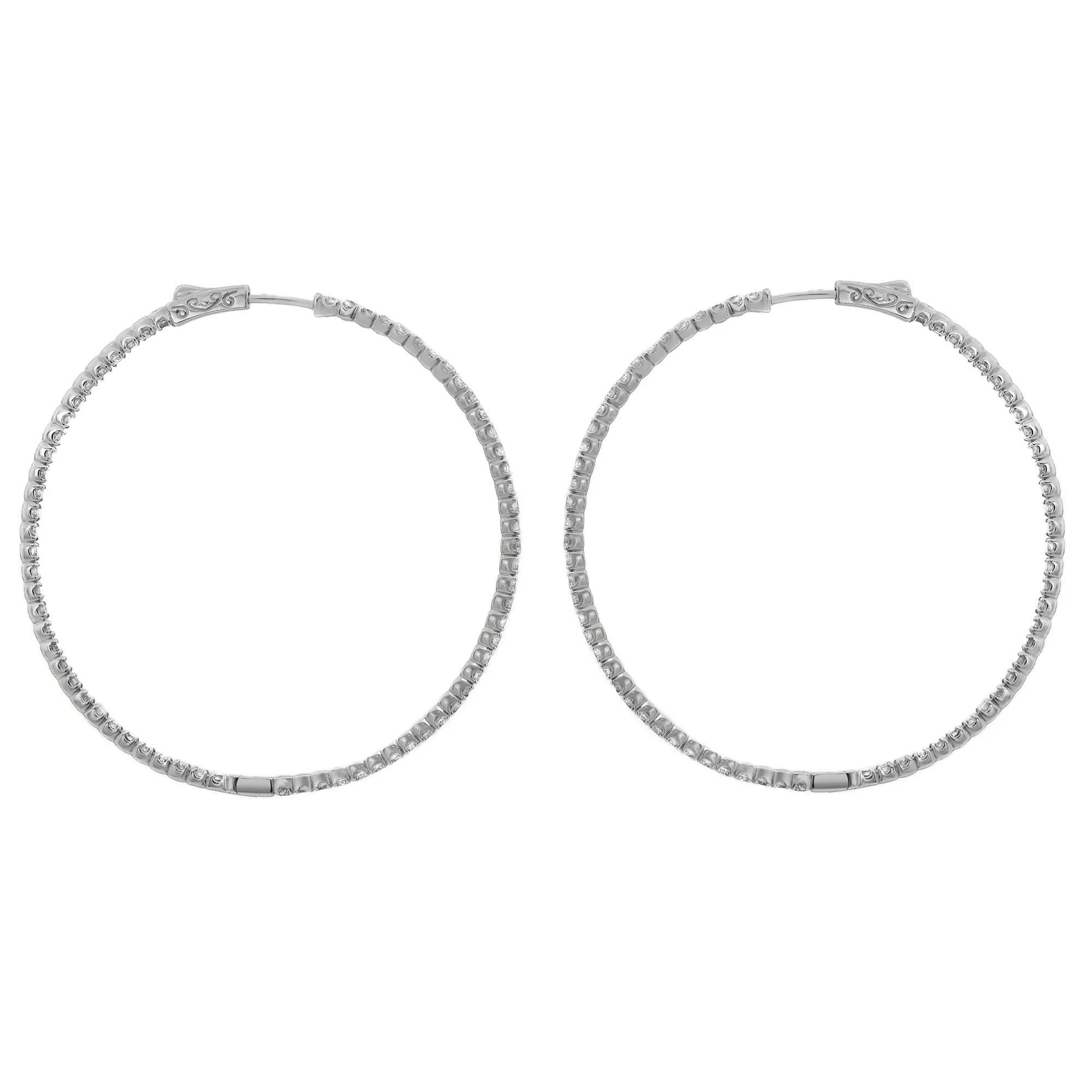 Add a touch of sparkle to your look with these beautiful large inside-out diamond hoop earrings. Expertly crafted in high-quality 14K white gold, these earrings feature prong-set round brilliant cut diamonds, half on the outer hoop and half on the