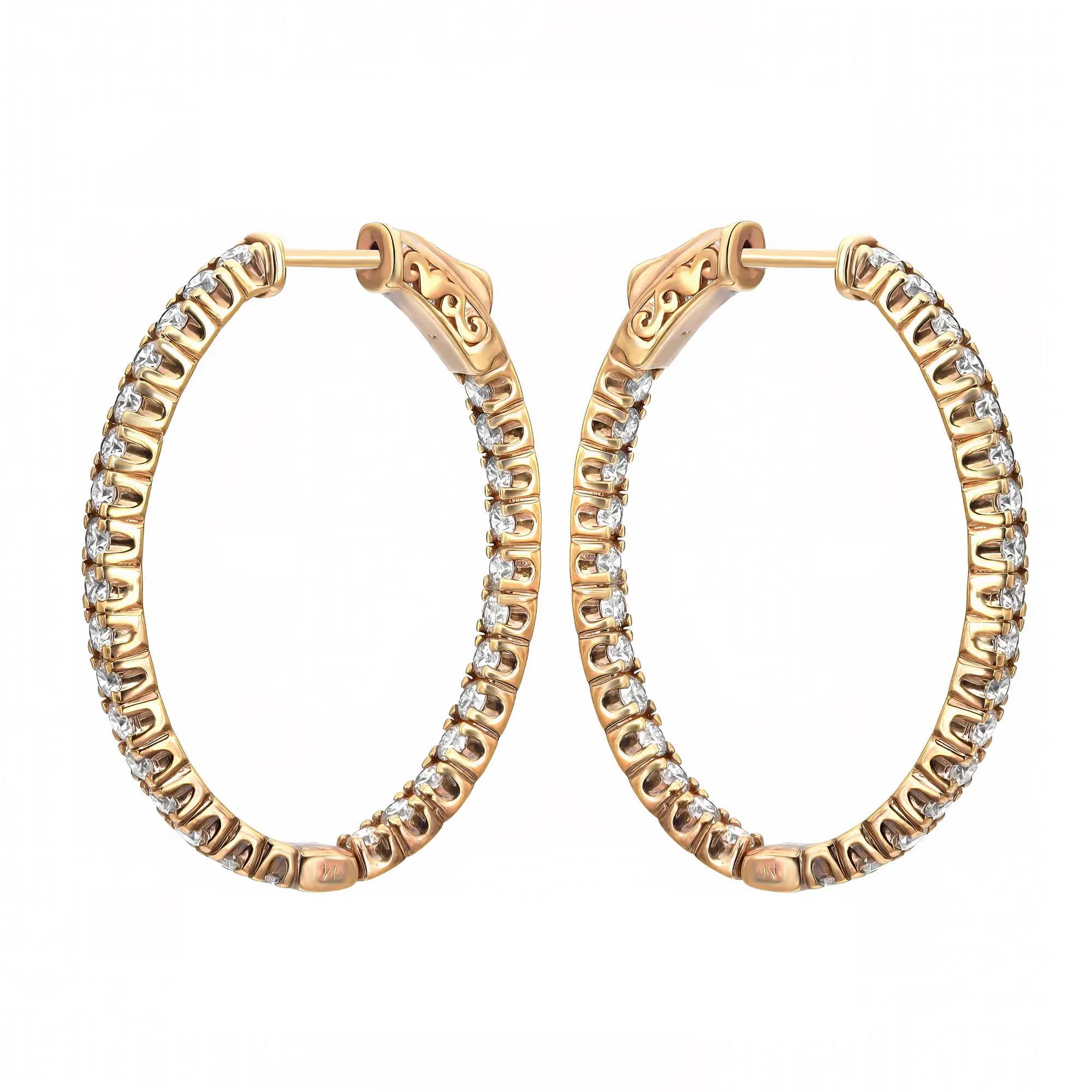 Sparkle all way with these beautiful inside out diamond hoop earrings. Crafted in fine 14K yellow gold. These earrings feature oval shape single line prong set dazzling round brilliant cut diamonds weighing 2.90 carats. The diamonds line half of the