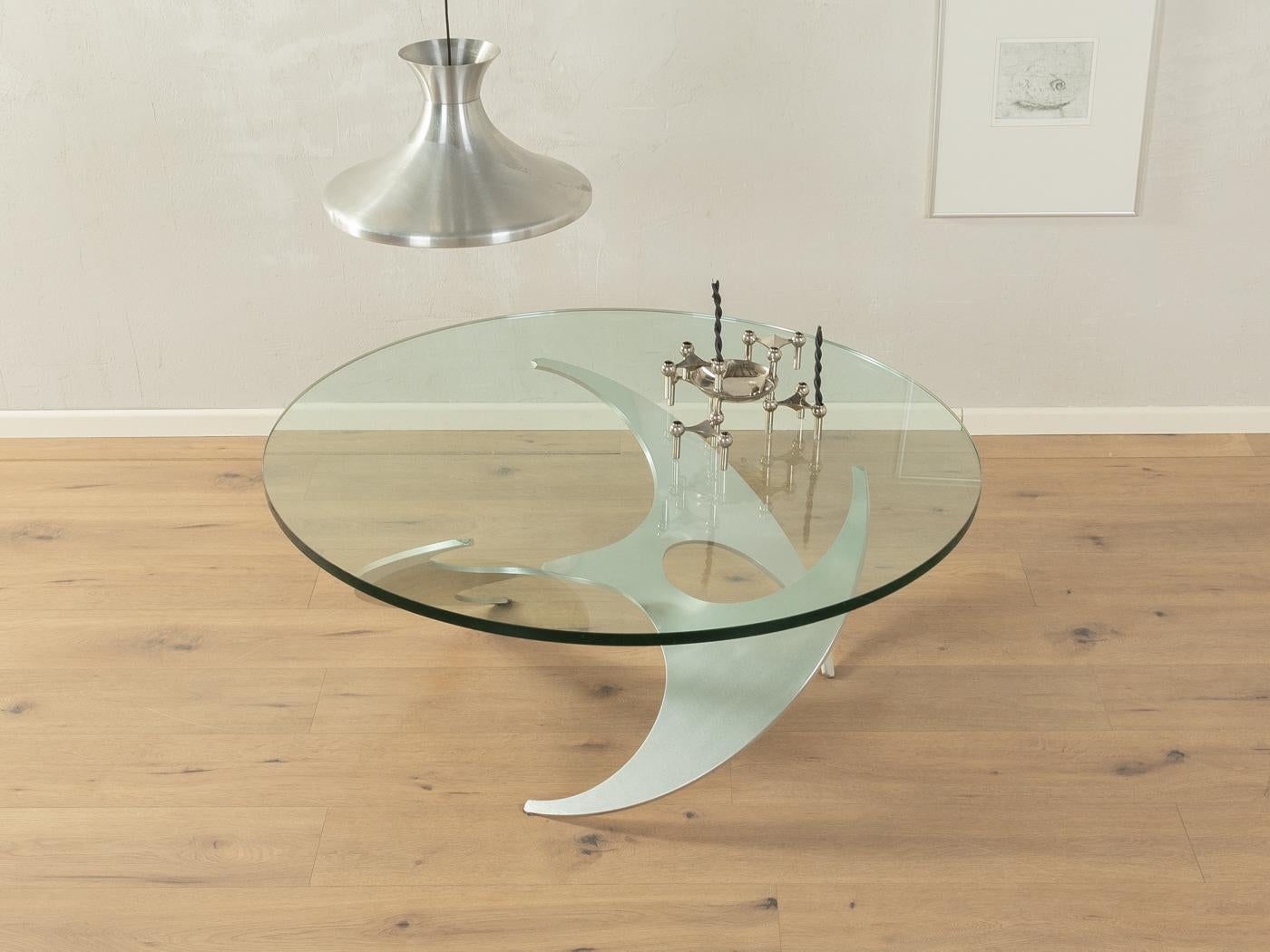 Sculptural propeller coffee table by Knut Hesterberg for Ronald Schmitt from the 1960s. 19mm thick glass top on high quality aluminum frame.
Quality Features:

    very good workmanship
    high-quality materials
    Made in Germany. Design: Knut