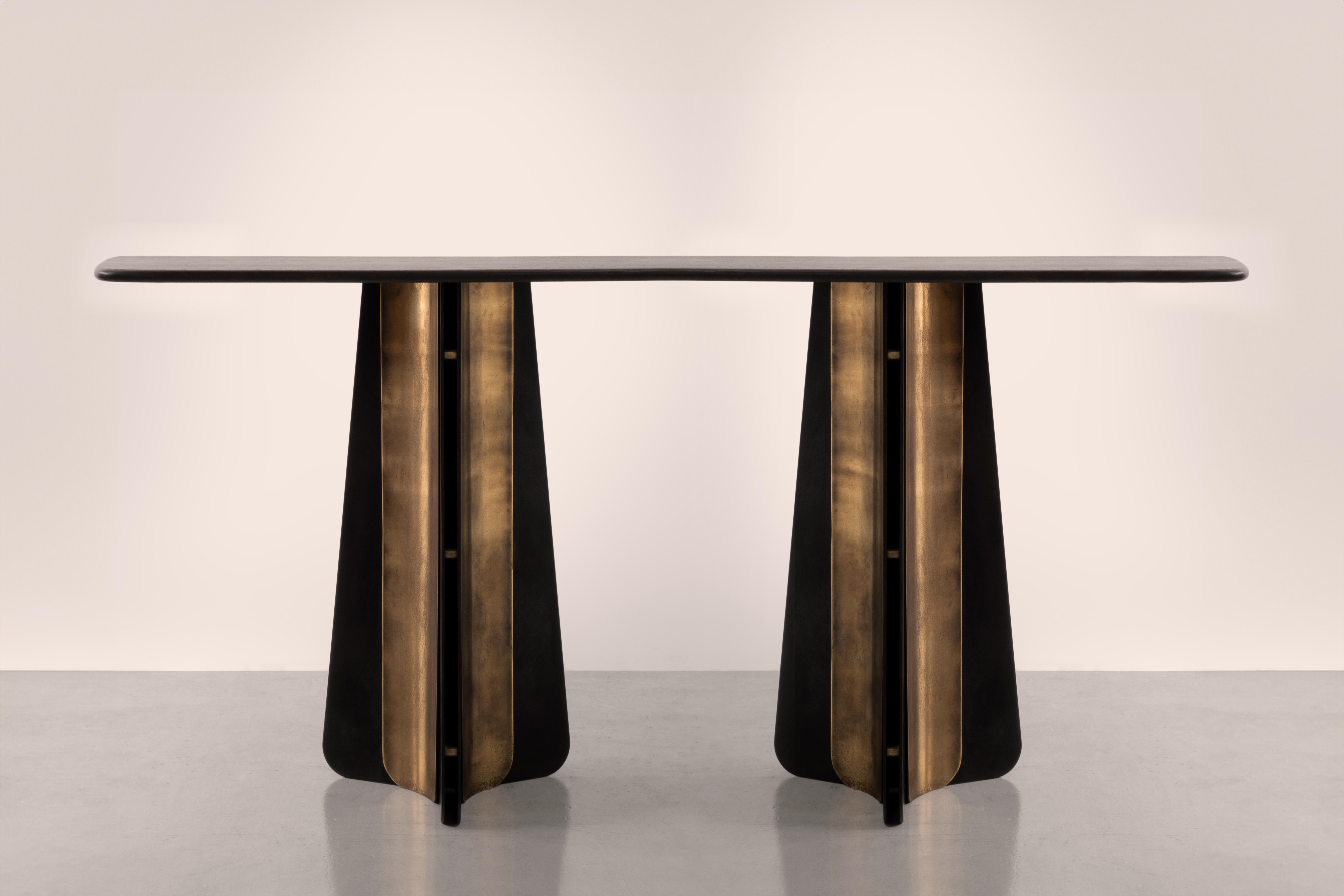 A table inspired by the sweeping curves of a ship's propeller blades and the art-deco golden age of the  ocean liner.

Pairing blackened steel and etched brass with bullnosed oak, Propeller is a fusion of the tactile and the structural. It pays 