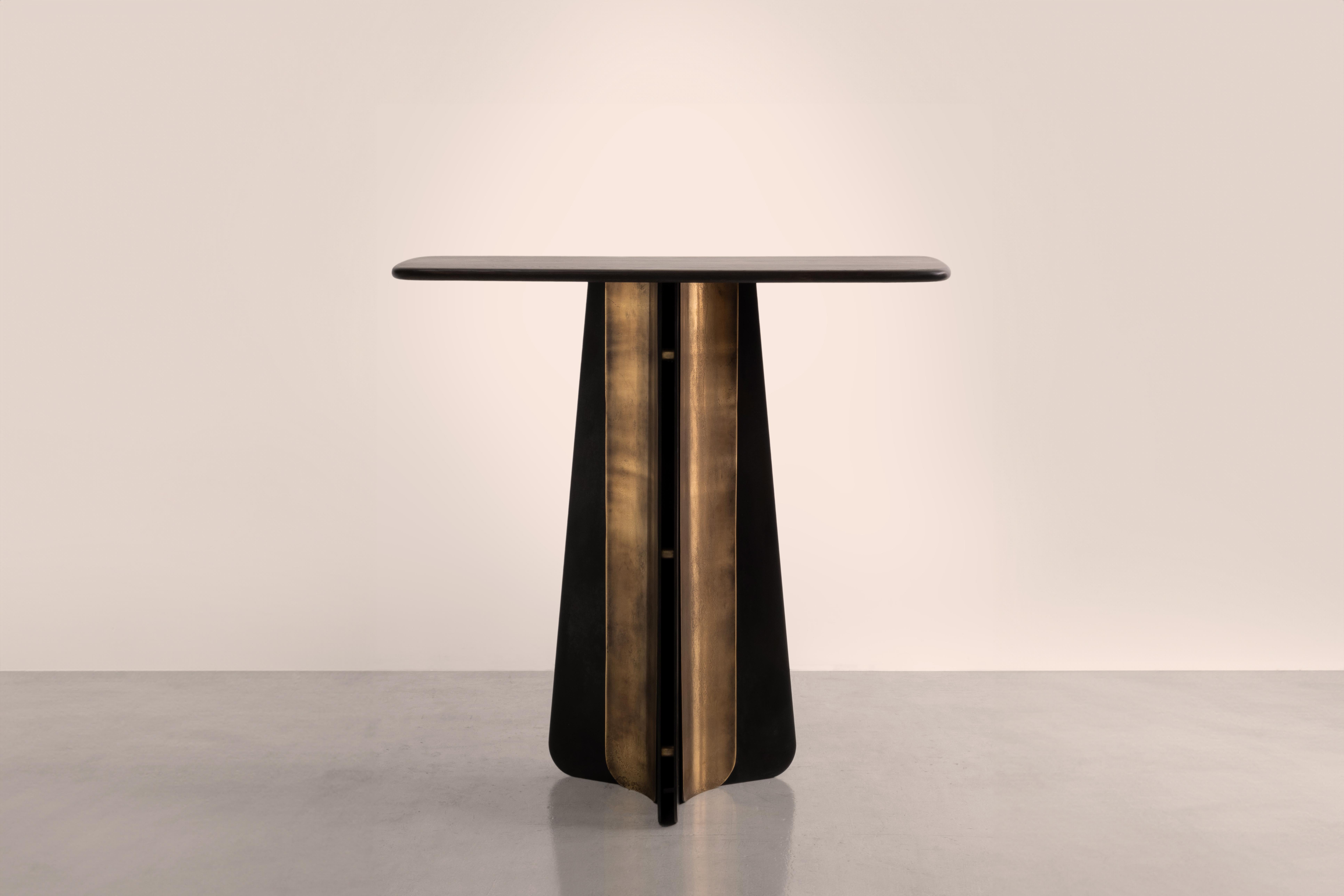 A table inspired by the sweeping curves of a ship's propeller blades and the art-deco golden age of the  ocean liner.

Pairing blackened steel and etched brass with bullnosed oak, Propeller is a fusion of the tactile and the structural. It pays 