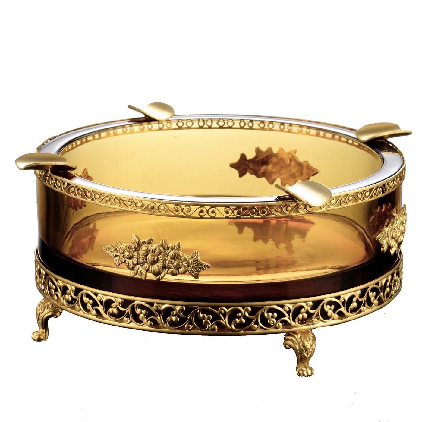 This magnificent ashtray was crafted of 24 PbO crystal with a delicate shade of amber and will make a statement in a classically furnished living room or study. Its simple silhouette is enriched by a clawfoot base in satin gold-finished bronze,