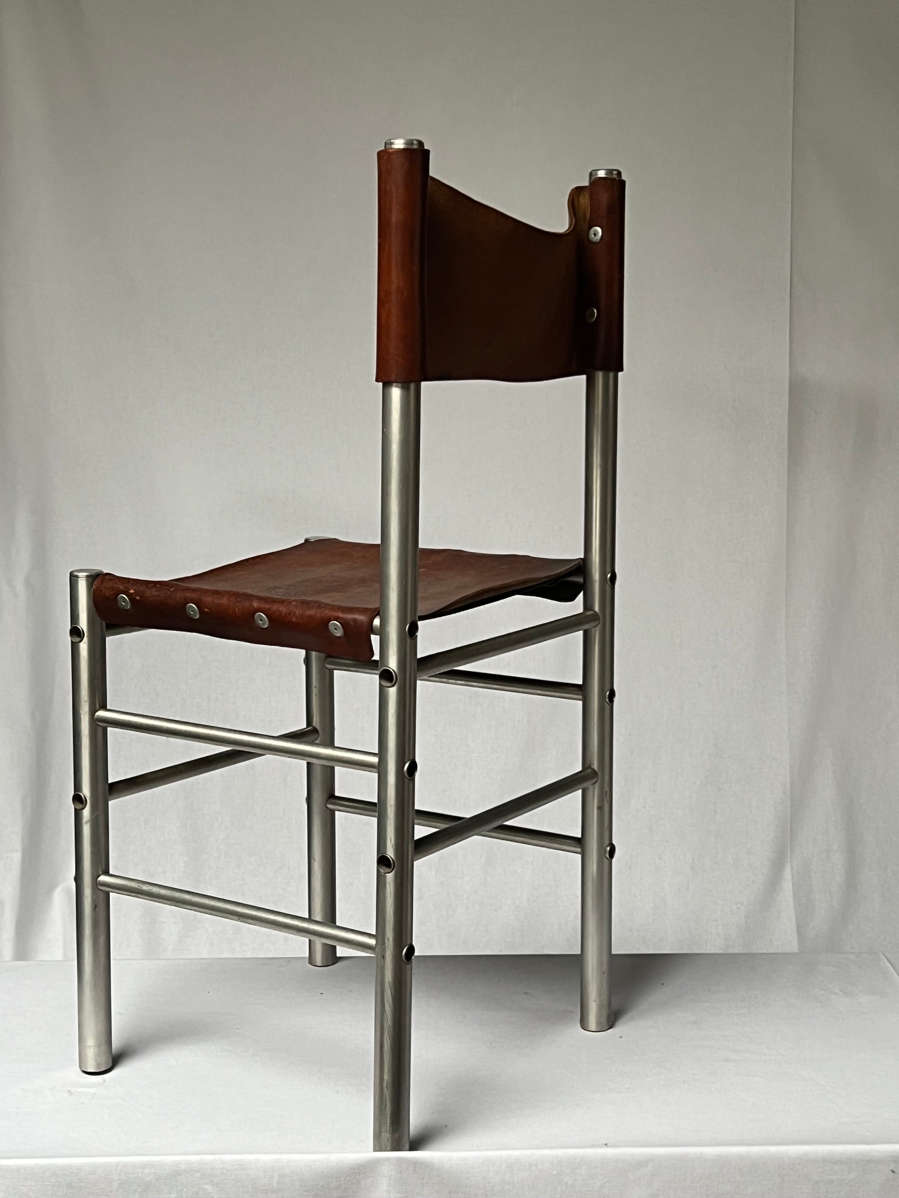 Very unique handmade aluminum tubular and leather chair. the dimensions are smaller than a regular chair. The height and seat height are standard. The overall is patinated and shows various shades of brown/brownish colors on the leather. Elegant and