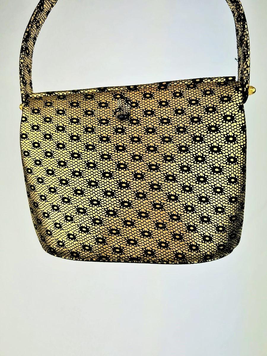 CIRCA 1950

Frankreich

Eleganter Prototyp einer Abendhandtasche von Christian Dior (zugeschrieben) aus den 1950er Jahren. Steife Tasche aus schwarzem Wildleder, bedruckt und mit Goldprägung versehen mit kleinen, an Schlangenhaut erinnernden