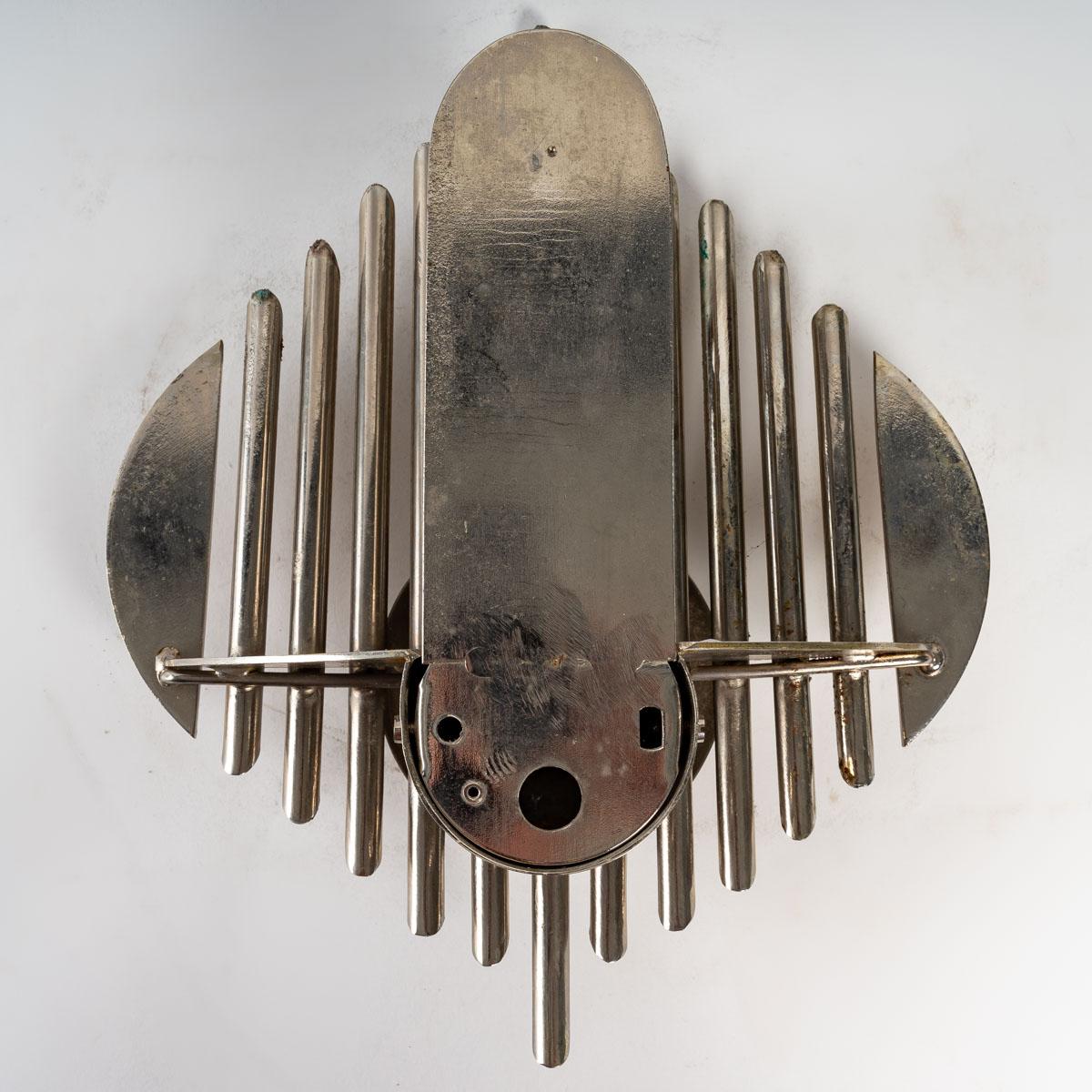 Prototype wall lamp in chromed metal with a futuristic organ motif. Electrification system on the back of the piece.
France, 1970s.