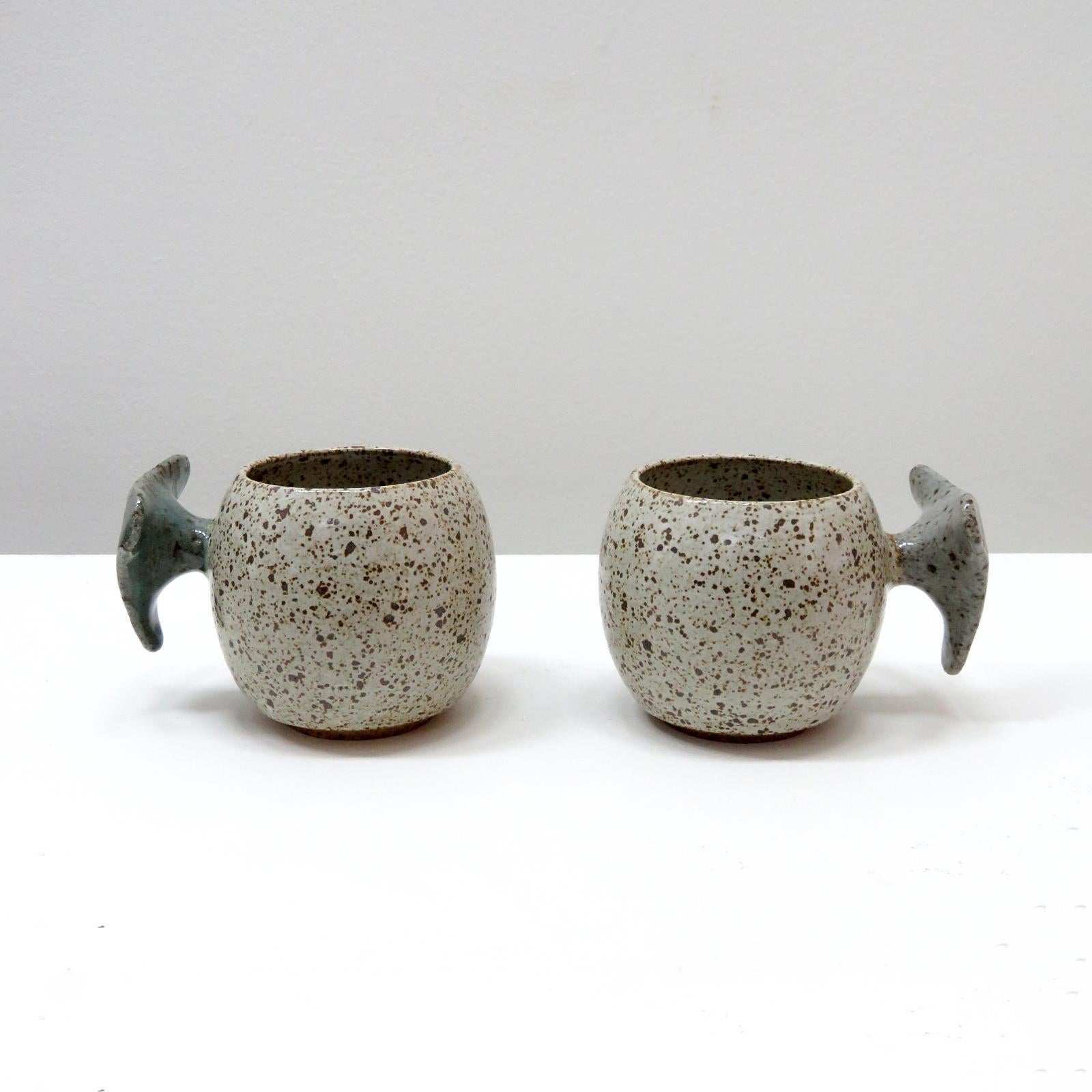 wonderful 'Valve' mugs, handcrafted by Los Angeles based ceramicist Jed Farlow. High fired stoneware with matte white speckled glaze. Designed with a human-centered approach in mind, these one-of-a-kind mugs are experimenting with handle designs to
