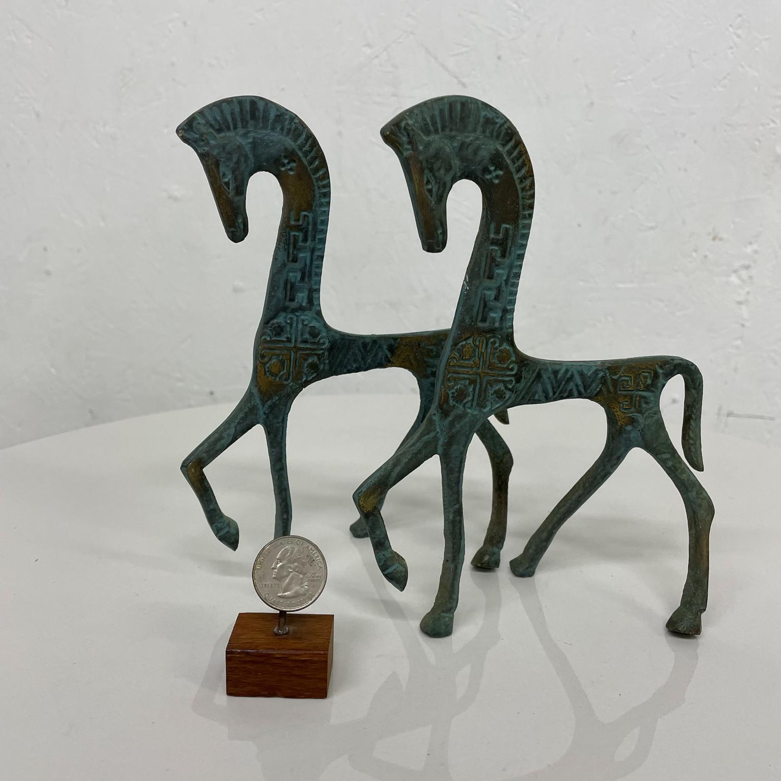 Horses
Proud pair of patinated bronze Etruscan horse sculptures.
Sleek modernist aesthetic.
In the style Karl Hagenauer bronze figures. 
Unmarked.
Measures: 7.25 H X 5.63 D X 2.25 W
Preowned original vintage unrestored condition.
Refer to images.
 