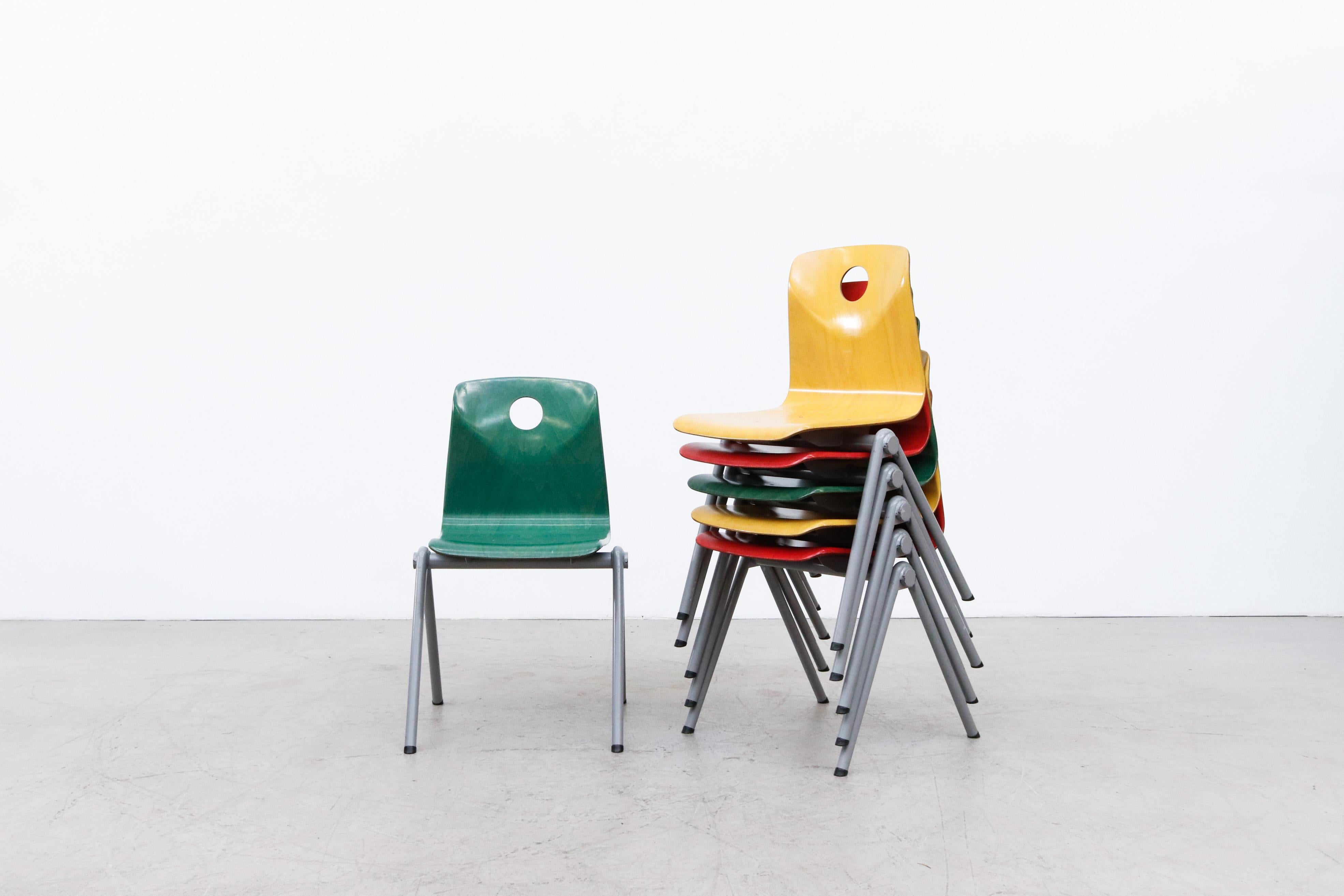 Multi-colored stacking school or restaurant chairs with grey enameled tubular metal frames. In good overall condition with some enamel wear and scratching consistent with age and use. Only Yellow and Red Chairs left. Priced individually. Other