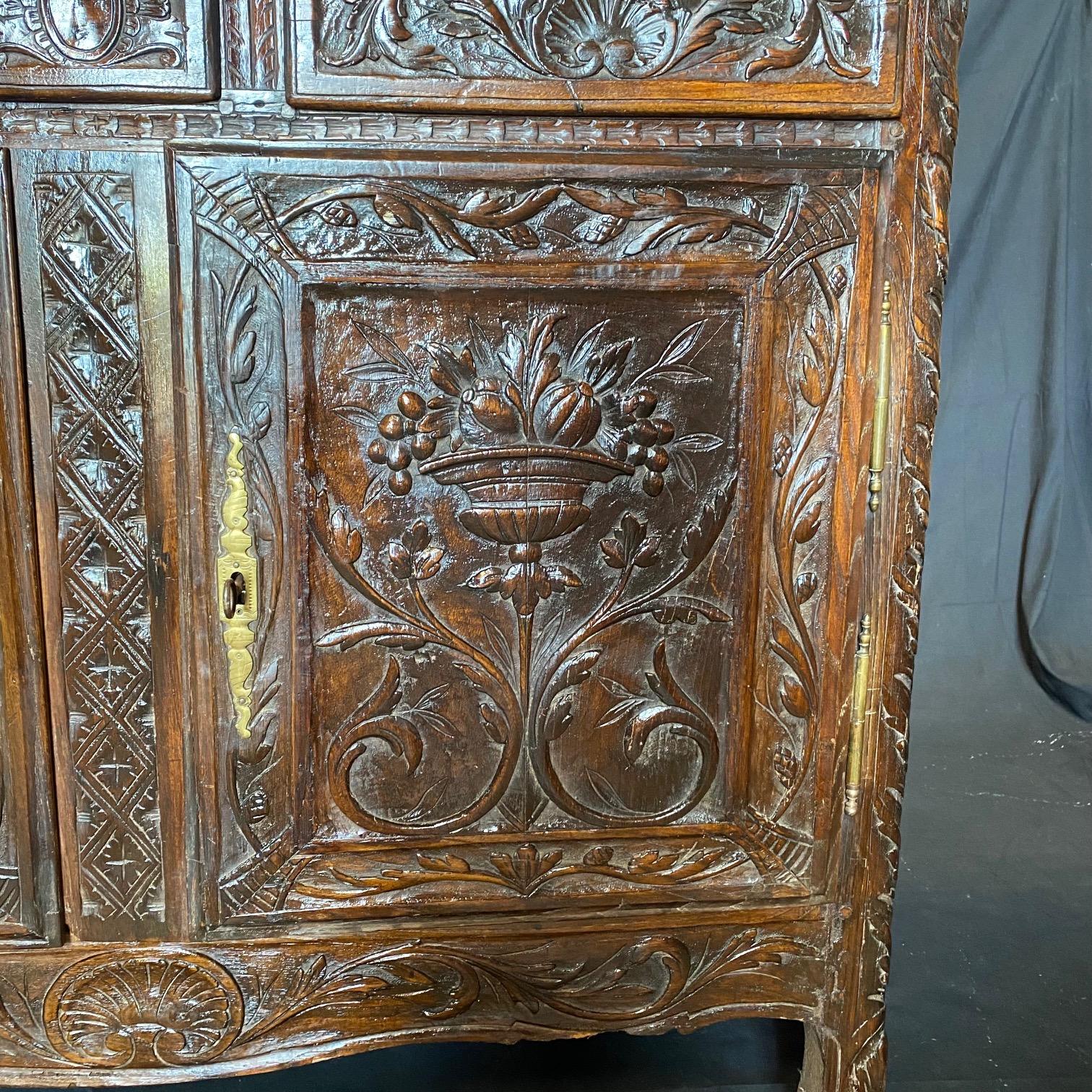 From the Provence region of France, this beautifully carved buffet has a 2 door large lower storage cupboard with a shelf, all under three upper hand dovetailed drawers,  artistically and intricately carved! What is most noteworthy on this piece are