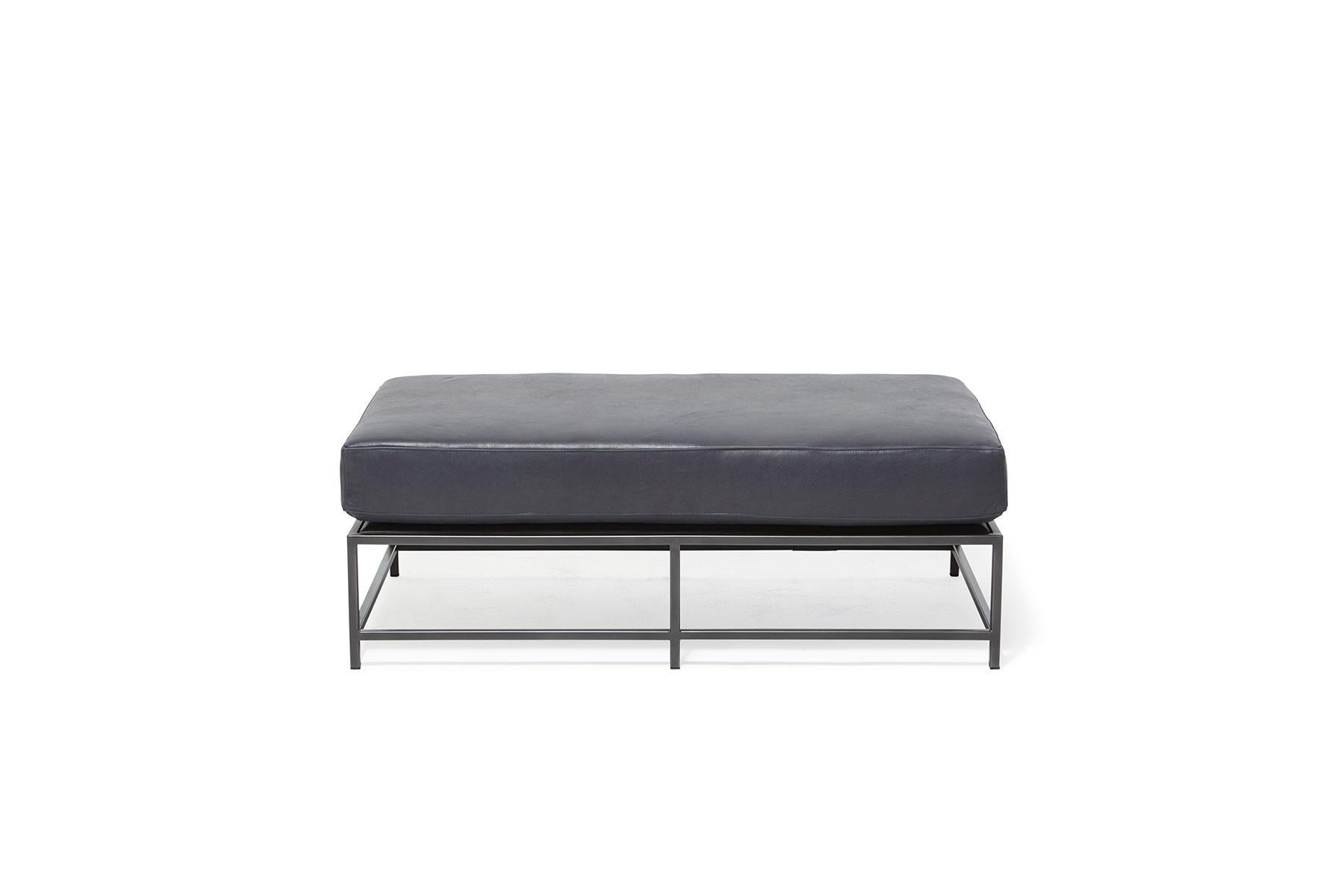 The Inheritance Bench is a versatile piece that can be used as a chaise extension on any sofa, as an independent seating option, or as a large upholstered coffee table. 

This variation is upholstered in a smooth blue leather from the Providence