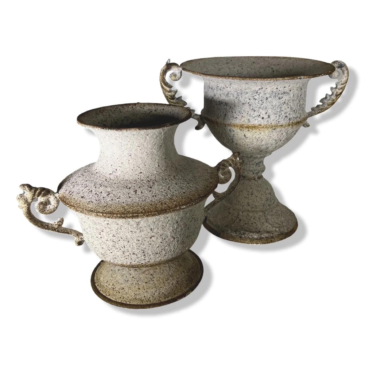This delightful pair of Province styled urns feature a textured patina and ornate handles. They are handcrafted from metal and have been artificially 'aged', to enhance their charm. They would be beautifully suited to holding large bunches of unkept