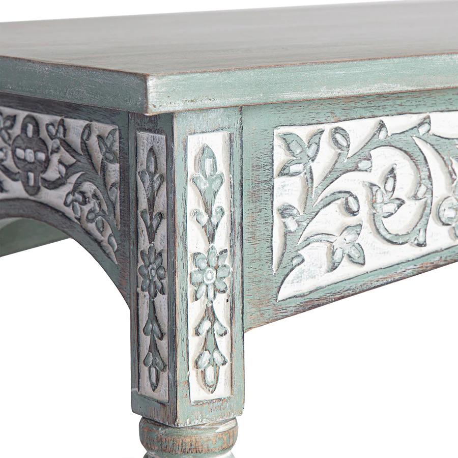 Stylishly striking, this charming vert tinted white washed console table is perfect for hallways, foyers and entrances. The graceful arched aprons with their inlaid carvings create a perfect platform for the functional tabletop whilst the top blocks
