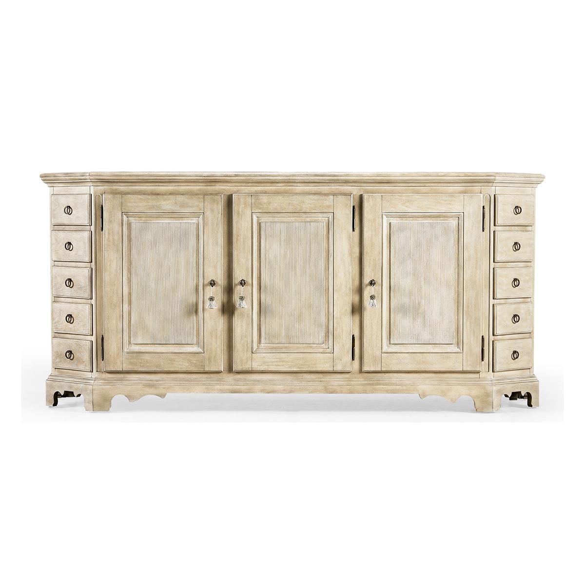 Provincial Buffet sideboard, handsome and refined, the sideboard has a unique canted corner design with thirteen hand-crafted drawers. Behind classically sculpted doors finished in nordic wheat, three interior drawers feature removable felt-lined