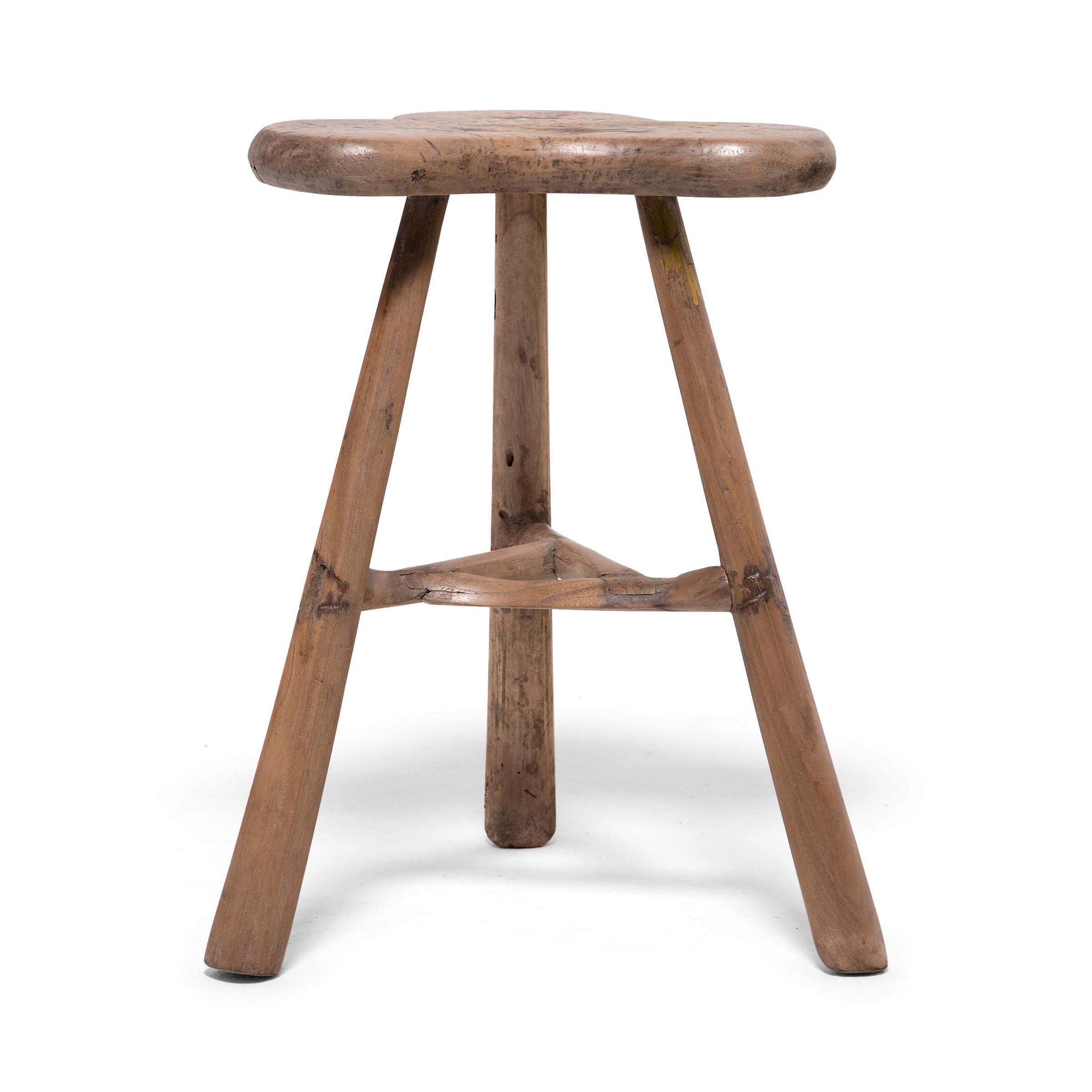 Crafted of Chinese cypress using mortise-and-tenon joinery, this everyday stool from Hebei province has a relaxed presence and a graceful silhouette. Three gently tapered legs support a trefoil seat, which has been shaped to resemble a butterfly, a