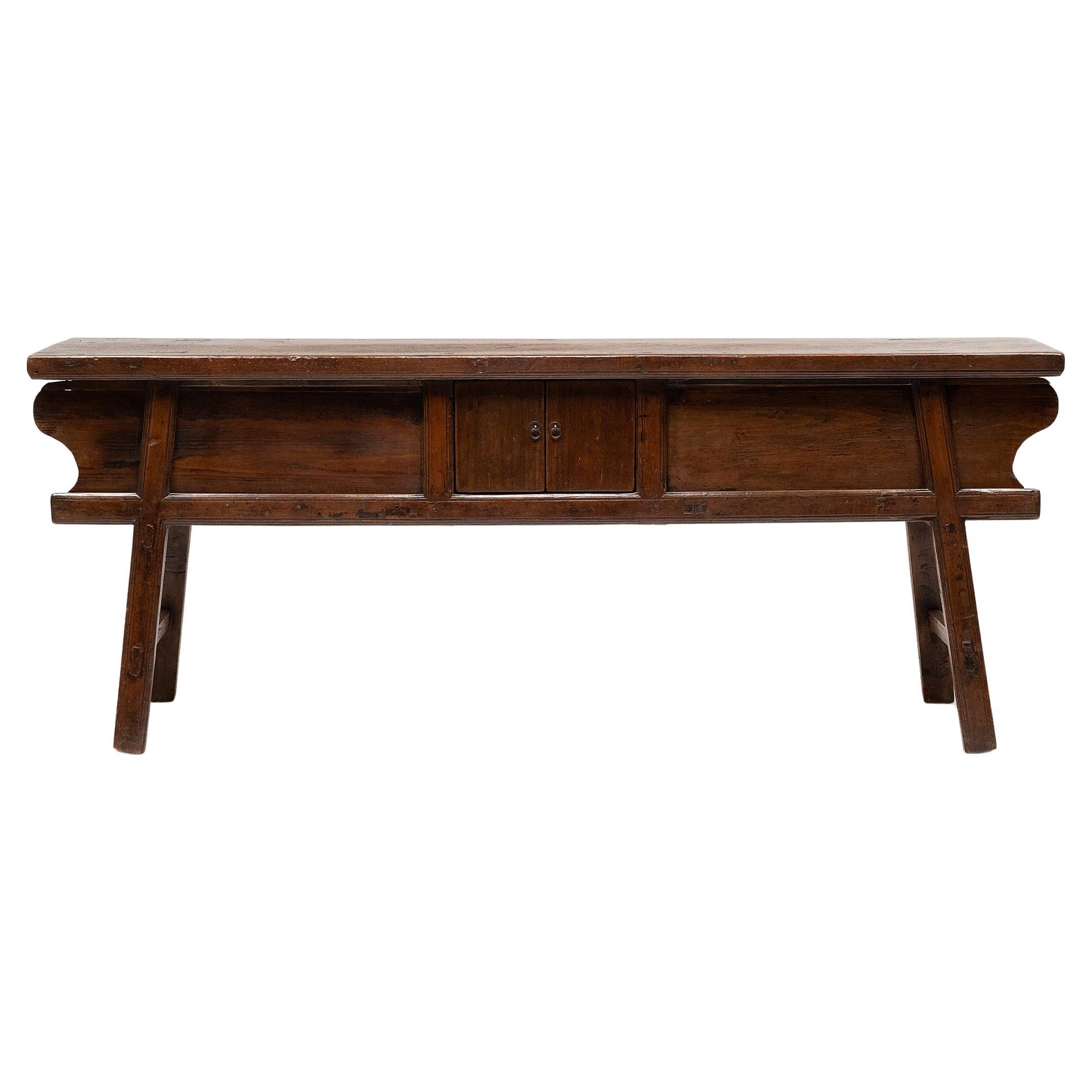 The warm tones and active grain of natural pine wood are the focus of this unusually articulated Dongbei coffer table. Made for a provincial home in northeastern China, this table was once used to honor loved ones past and present with photos or