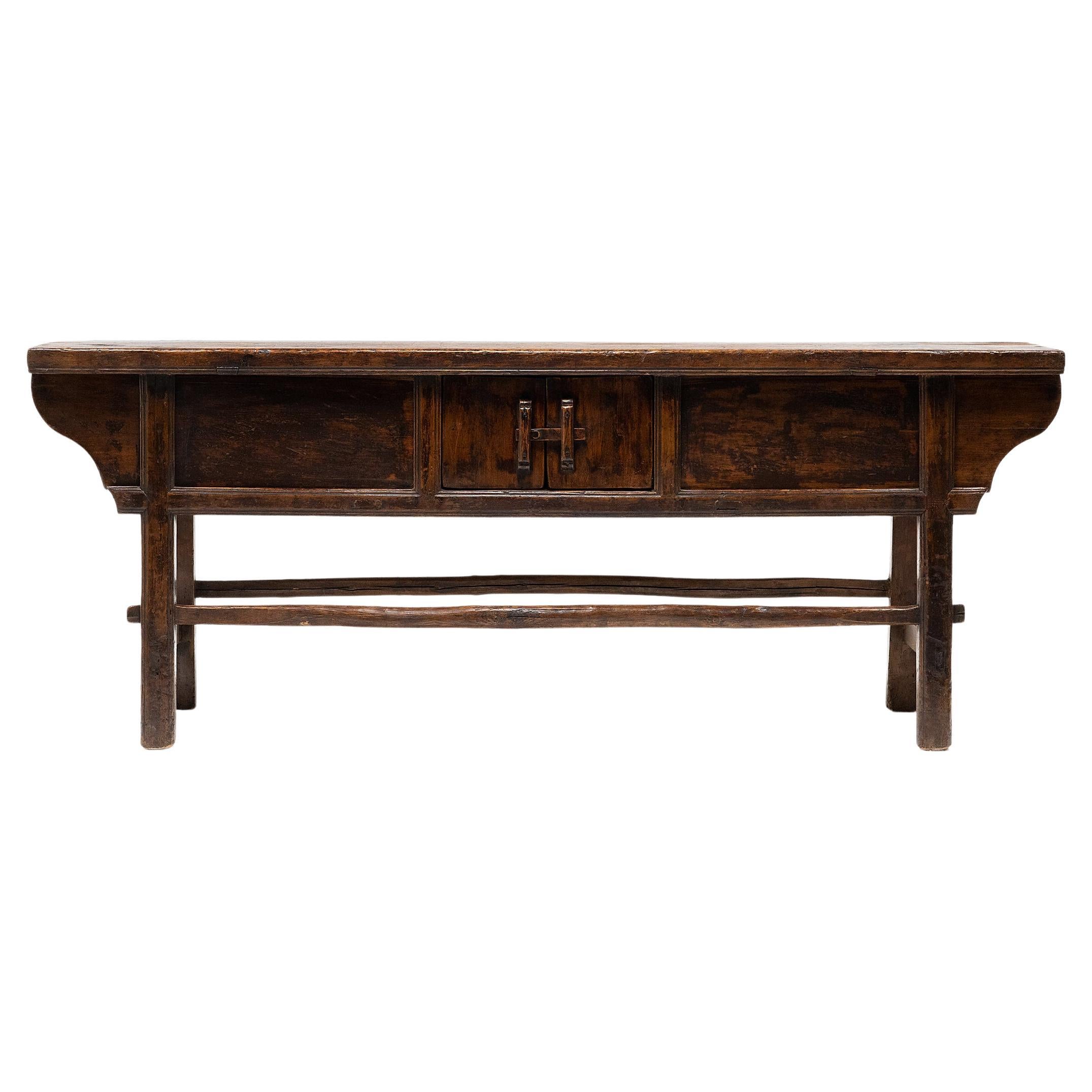 The warm tones and active grain of natural pine wood are the focus of this unusually articulated Dongbei sideboard. Made for a provincial home in northeastern China, this table was once used to honor loved ones past and present with photos or other