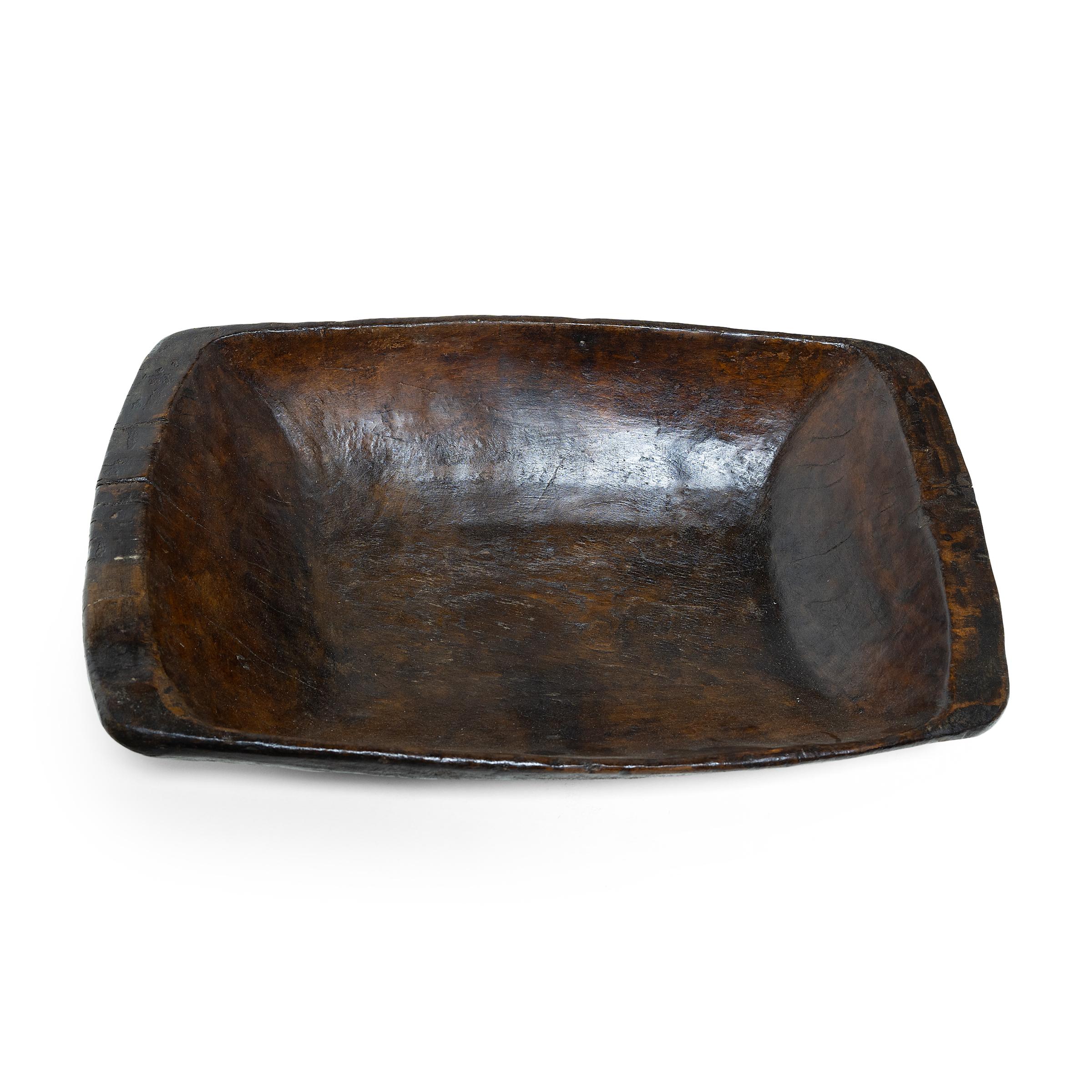 This hand-carved wooden tray from northern China charms with rustic texture and simple form. Years of use have rounded the edges and imparted a well-worn, wabi sabi texture. Originally used in a provincial farm or kitchen, the tray brings a touch of