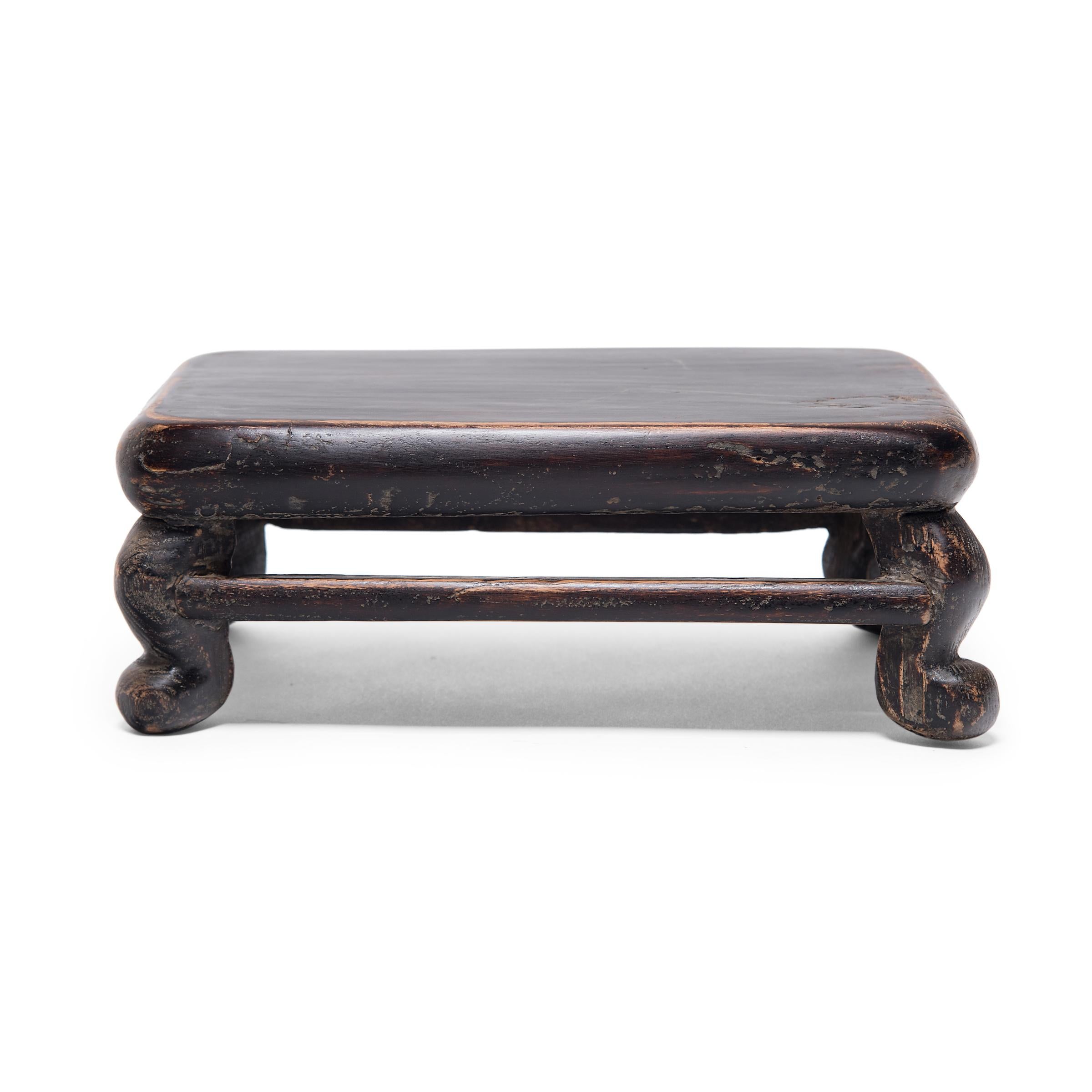 For thousands of years, precious Chinese artworks have been elevated for display on fine wooden table stands. Recognized today as works of art in their own right, these display stands are typically finely carved, crafted of exquisite hardwoods, or