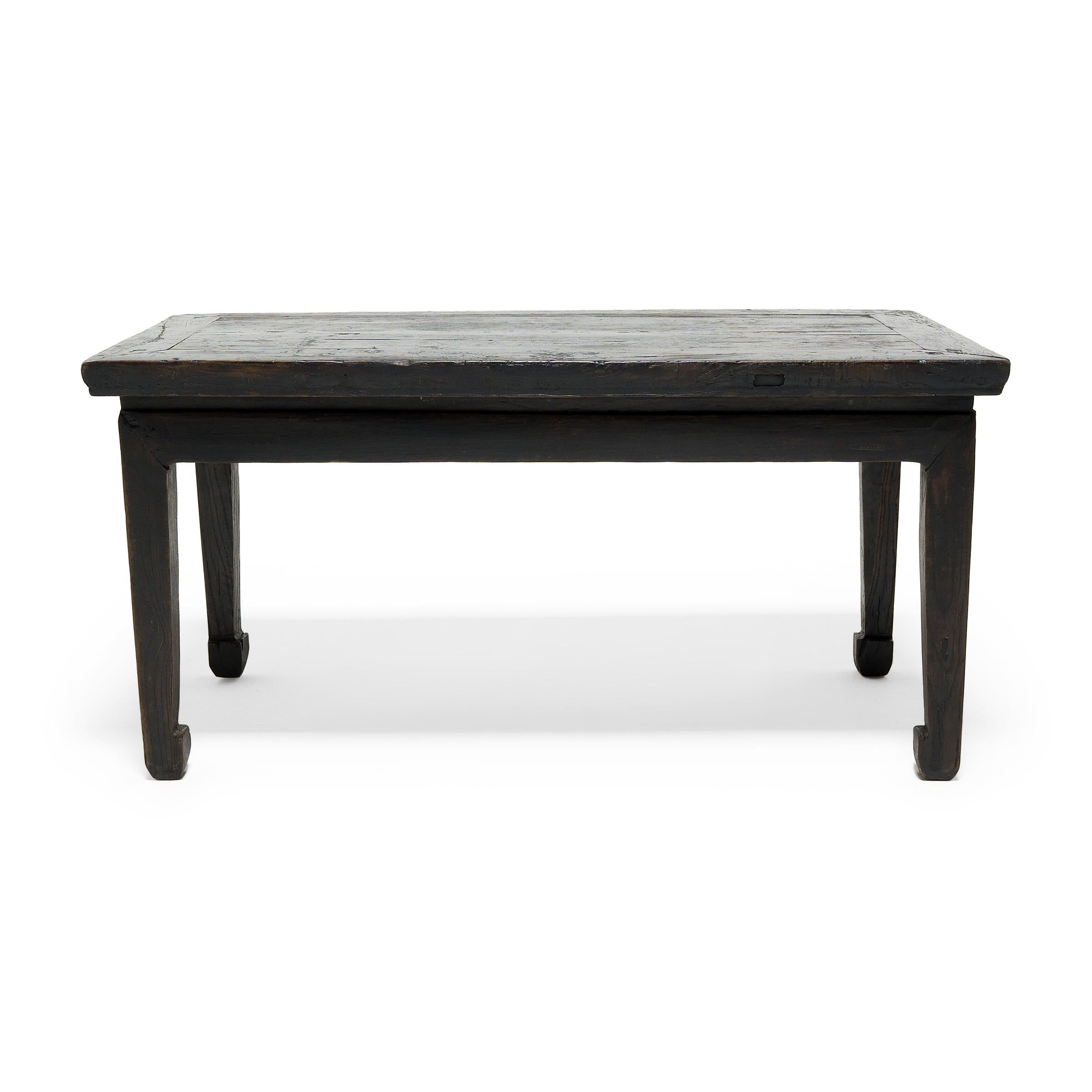 With clean lines and a simple Silhouette, this 19th century half table from Shanxi province expresses the restraint of classical Chinese furniture design. Crafted of northern elm (yumu) with mortise-and-tenon joinery, the table's streamlined form