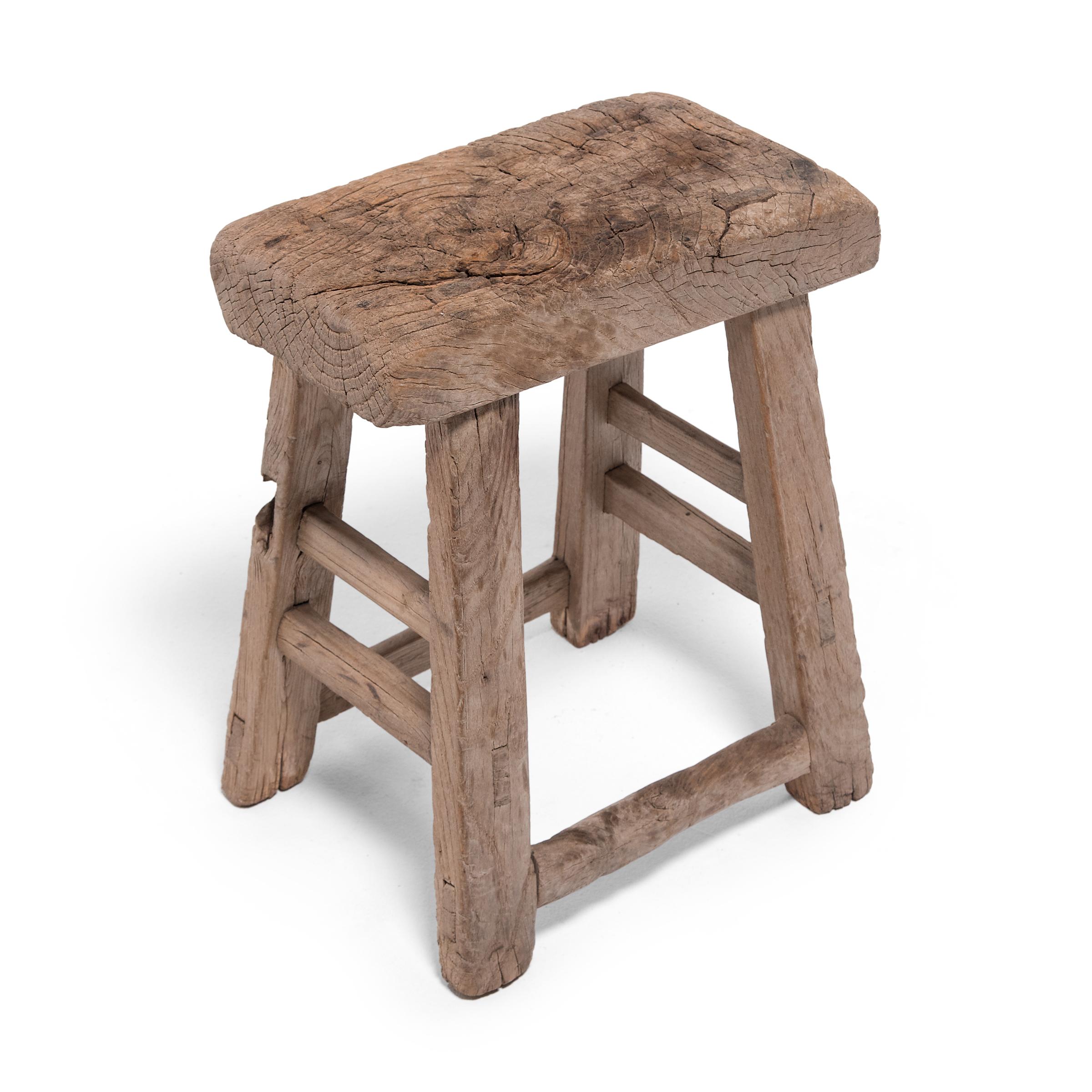 Dated to the early 20th century, this simple stool from China's Hebei province would have been used throughout a courtyard home as lightweight and versatile seating. The stool's rectangular seat was rift-sawn to reveal grain patterns running