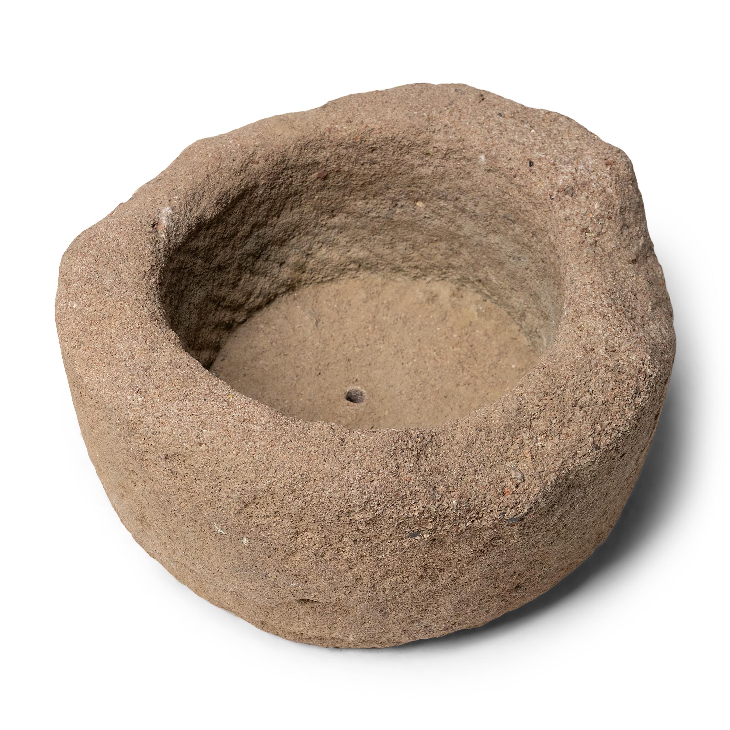 Once used on a provincial Chinese farm to hold water or animal feed, this 19th-century stone trough is celebrated today for its organic form and rustic authenticity. The low trough is hand-carved from solid granite to a rounded, full-moon shape,