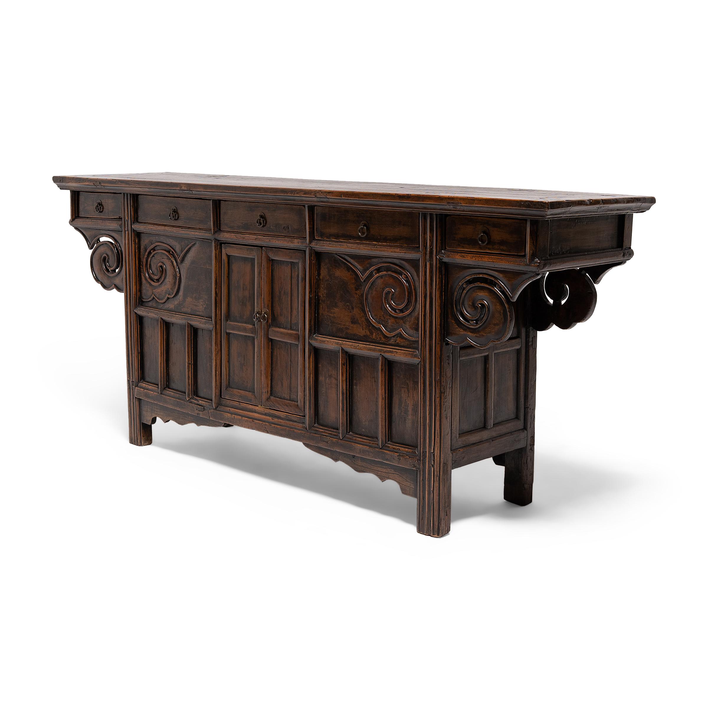 This provincial altar coffer from the mid-19th century is beautifully designed with inset panels, bold carvings, and a fantastic, richly aged patina. Given its large scale and expansive table top, the coffer was likely used as a family altar for