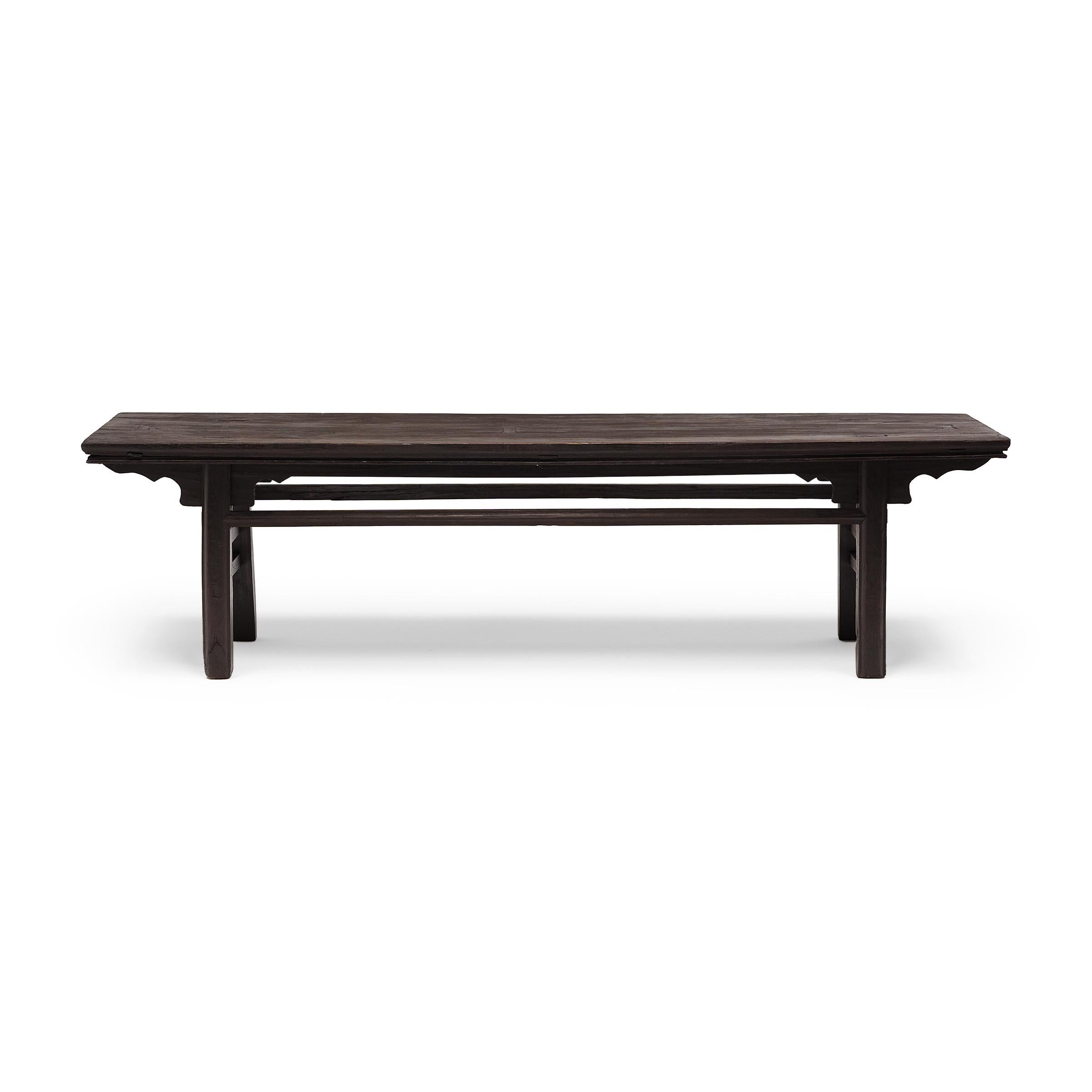 This rustic bench from China's Shanxi province follows the classic recessed-leg form, defined by legs that are set back from the top edge and slightly splayed for stability. Popular since the Song dynasty, the recessed-leg design is widely