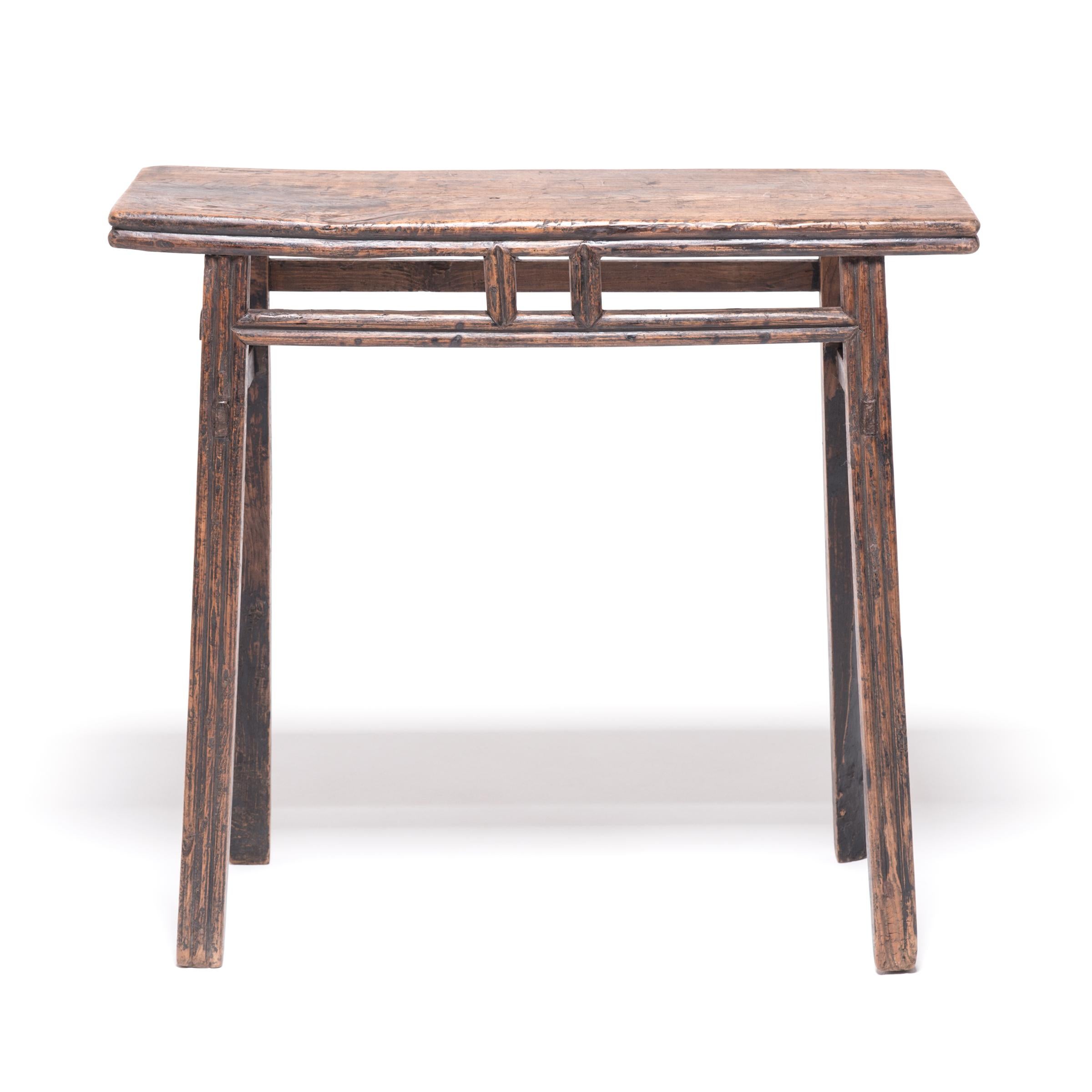 Crafted in China's Shanxi province in the late Qing dynasty, this charming wine table was once a gathering spot for guests to pour wine and make toasts. The table's stretchers and legs were hand rounded to create a barreled form, meant to resemble