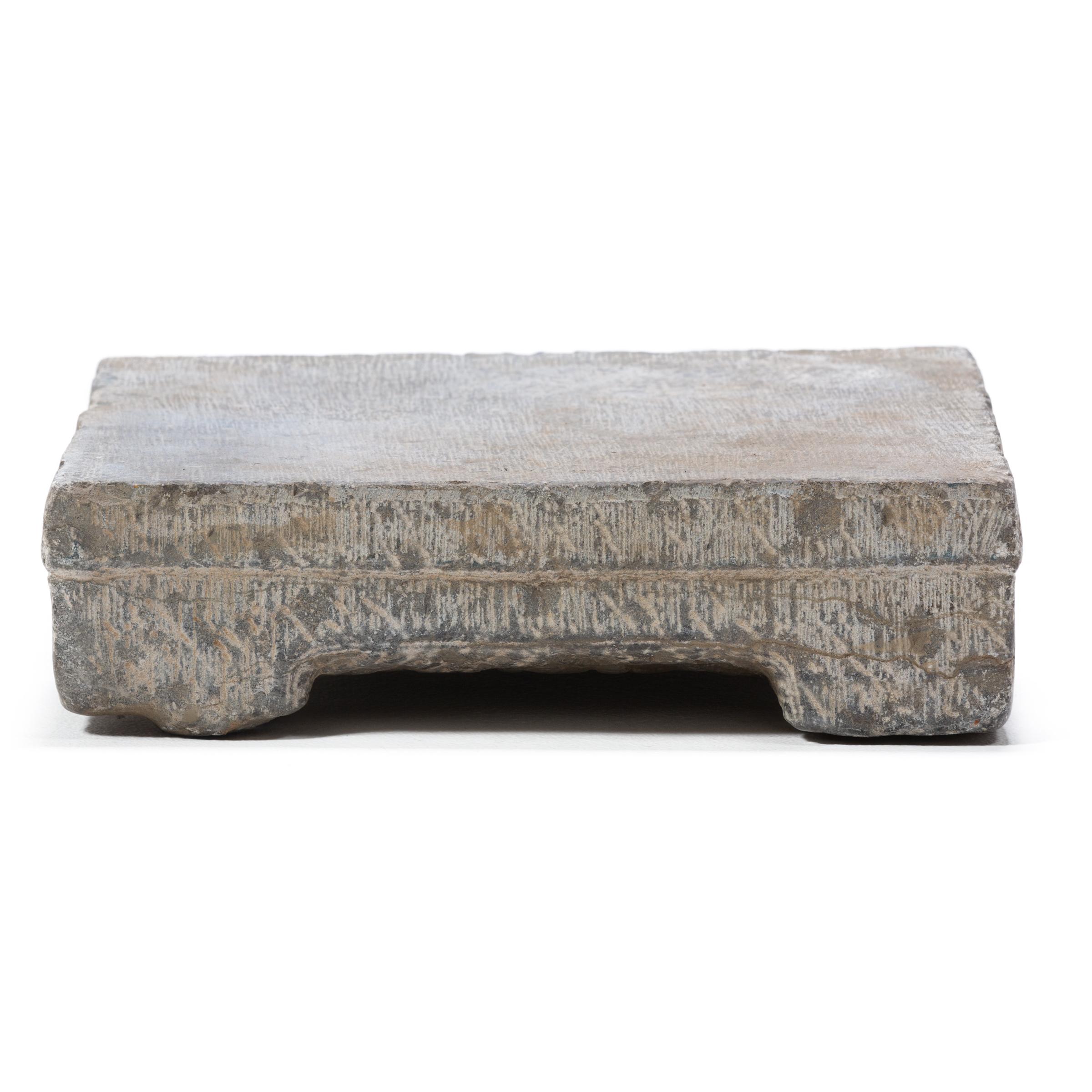 Carved in the late 19th century in northern China, this limestone washing stone would have been used by a Qing-dynasty woman for washing clothes and textiles. Used by beating wet fabrics against its smooth surface with a wooden washing stick,