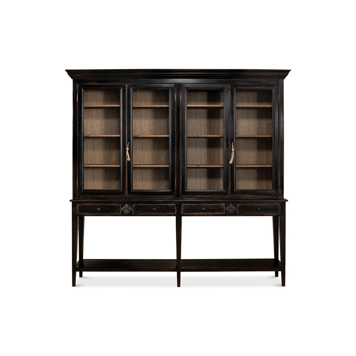 Provincial-style pine painted display cabinet. The display case has remarkably subtle details such as slightly splayed legs that are tapered and encase the bottom shelf. Crown molding, with glass front doors that expose a contrasting interior