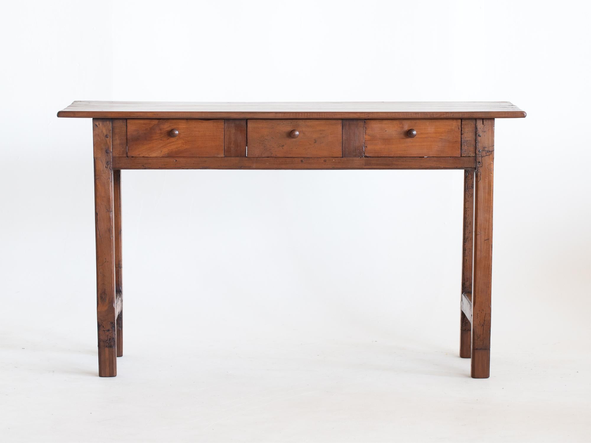 A three-drawer cherrywood serving table or console adapted from a larger 19C French farmhouse table.

Stock ref. #2177

In good sturdy order. Characterful wear to the aged timber. Treated and filled worm holes.

77 x 132 x 42.5 cm

30.3 x 52.0 x