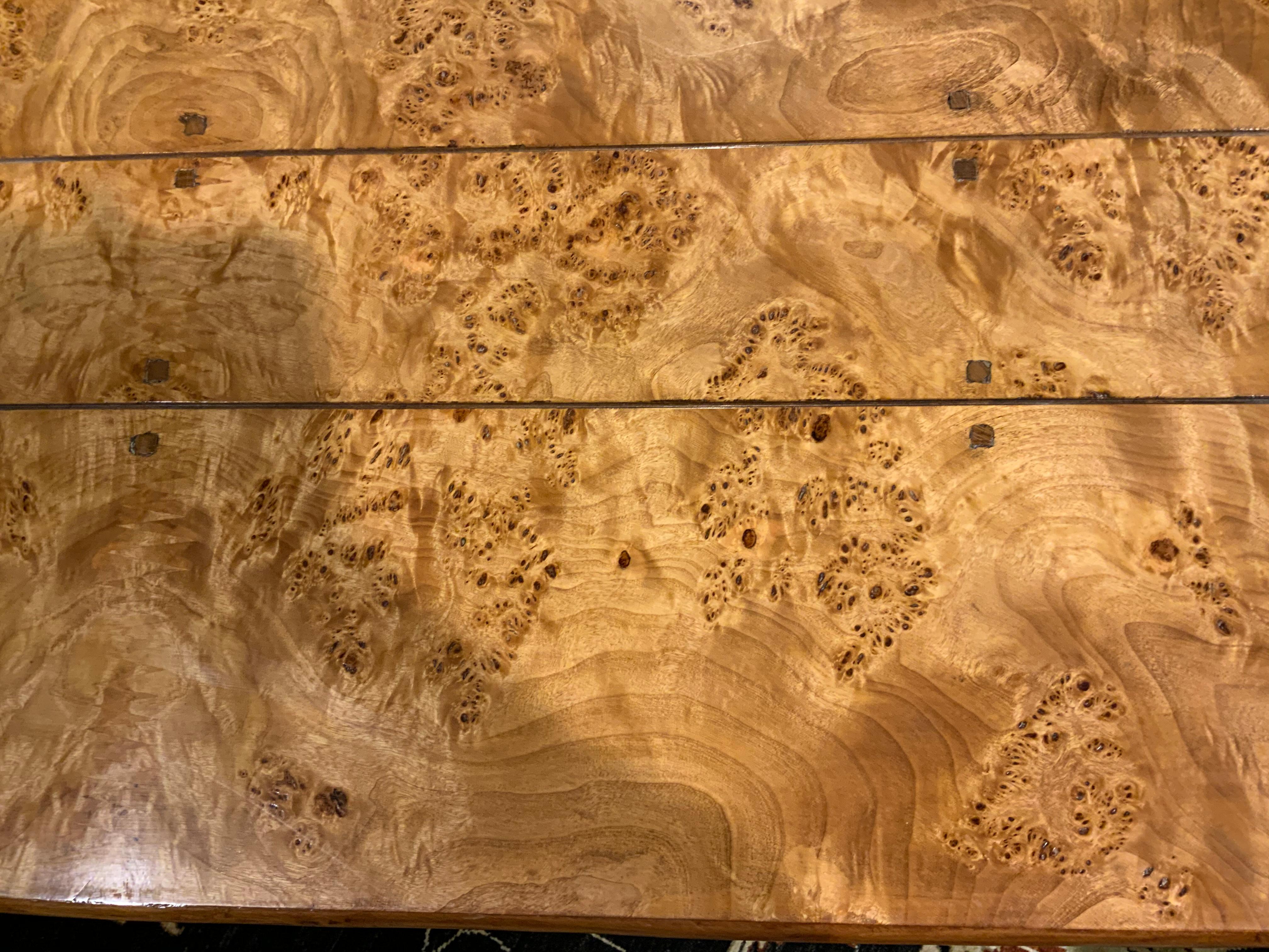 This rectangular burl elm wood top mounted to a conforming frame and raised
on shaped cabriole legs.