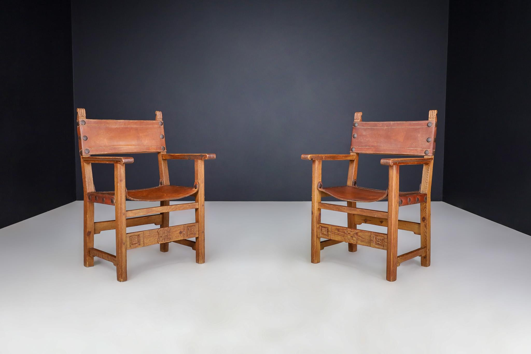 Provincial Mid-Century Armchairs in Patinated Cognac Saddle Leather, France 1950

This pair of mid-century armchairs beautifully represents the rustic elegance of French provincial design. Crafted in France during the 1950s, the chairs feature solid
