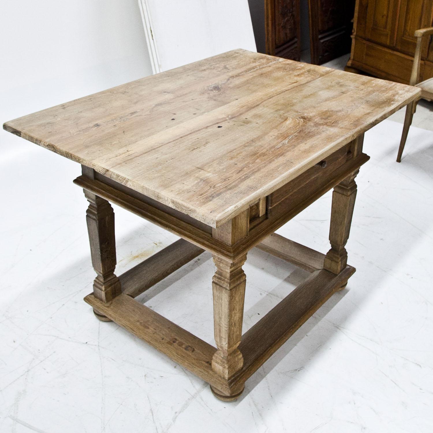 Franconian table with one drawer on profiled legs with strutting in between.