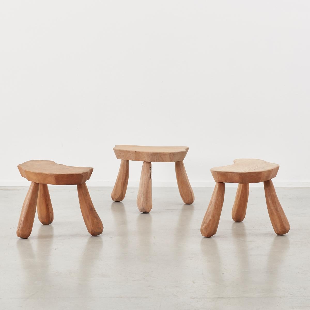 This quirky set of stools crafted from hardwood harks back to a primitive and purist form of carpentry. Each element of the stools is hand whittled so that all but the top surfaces are multifaceted. This effect gives the stools a charming Flintstone