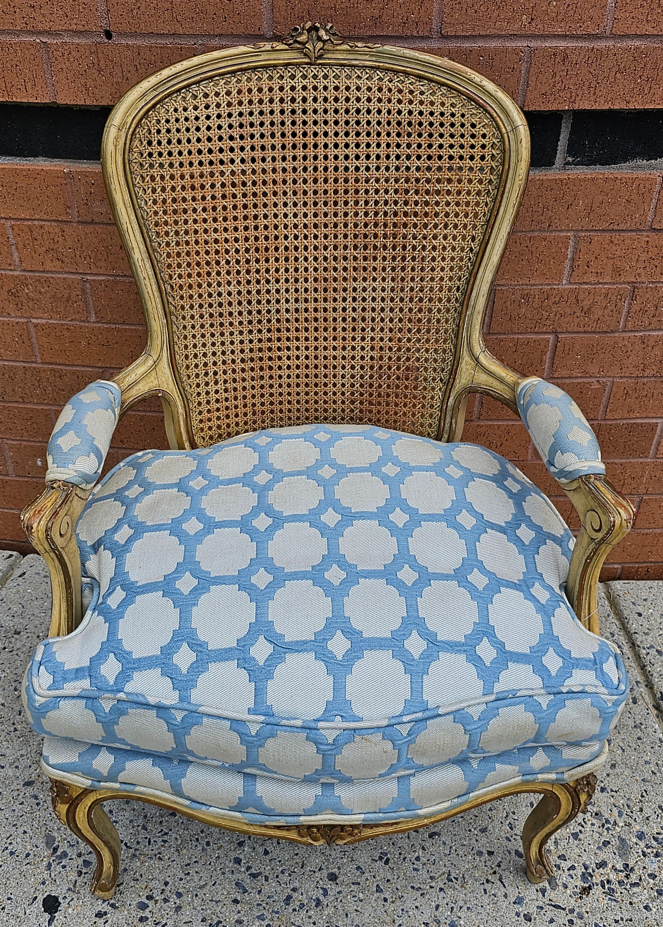 A French Provincial style Yellowish Enamel, Caned Back And Upholstered Seat Bergere Chair in very good vintage condition.  Duck feather soft seat cushion. Measures 25
