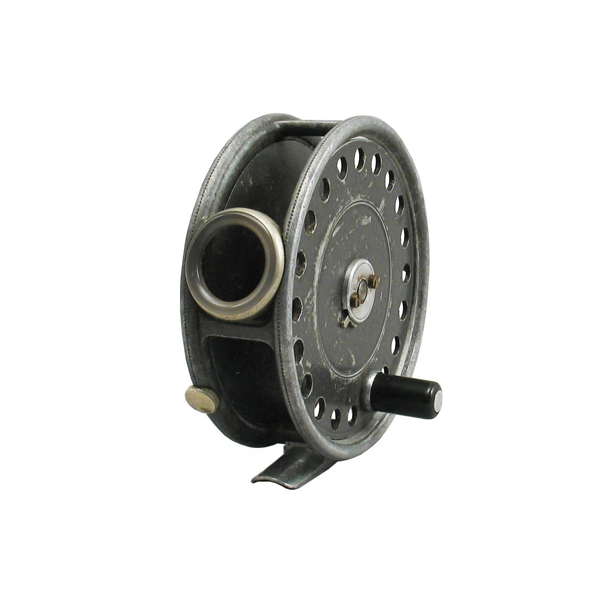 Pryce-Tannatt's personal fishing reel. This is a Hardy St. George alloy trout fly reel, it has a smooth agate line guide, rim tension regulator, brass foot modified two screw drum latch, smooth check, black handle and retains some original grey