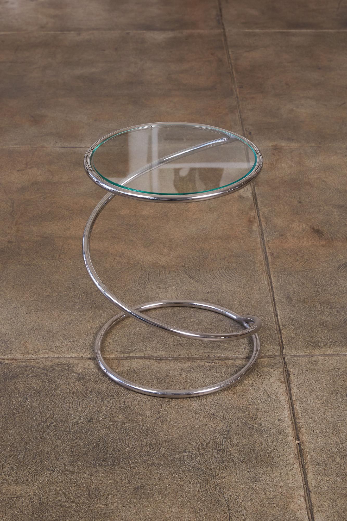 New York-based manufacturer Brueton specialized in elevated design using Industrial processes. On offer is a small round side table with a corkscrew base in their signature material, highly polished stainless steel. The tabletop is a partially inset