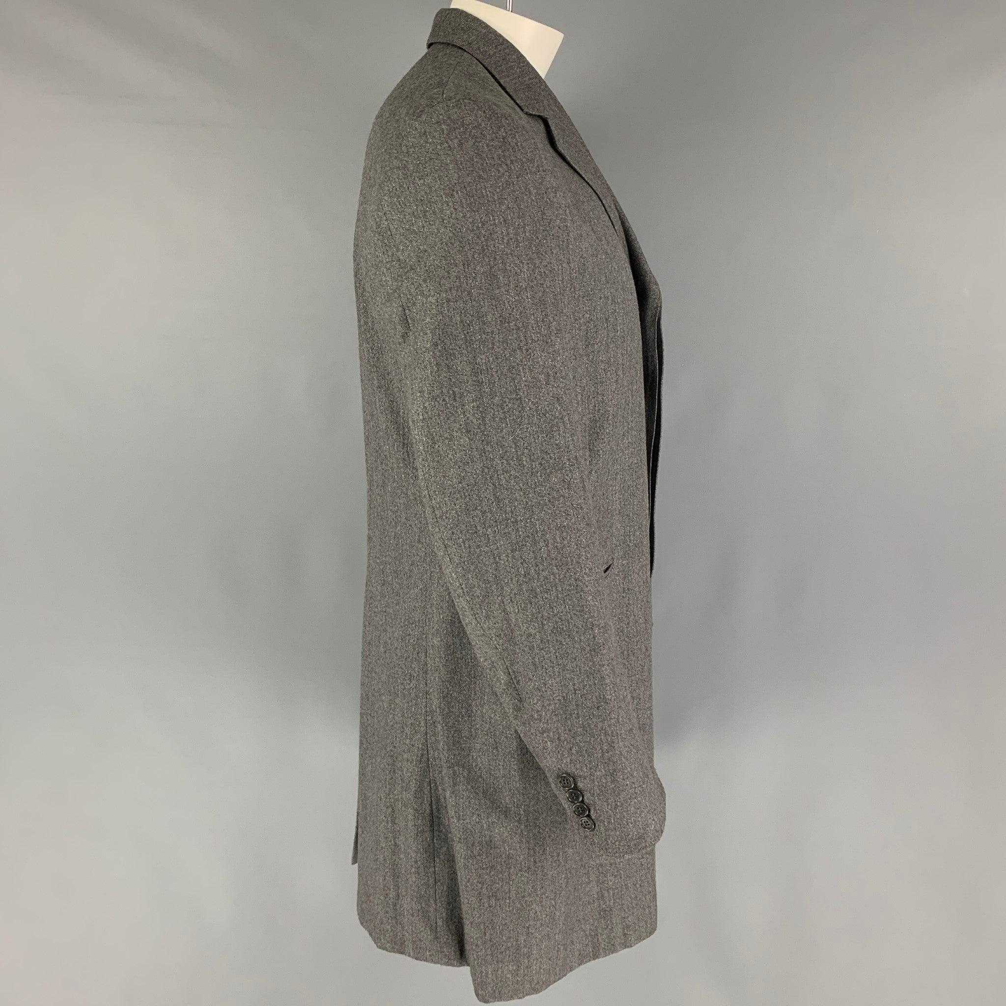 PS by PAUL SMITH coat comes in a grey wool with a full liner featuring a notch lapel, slit pockets, single back vent, and a hidden placket closure. Made in Italy.
Excellent
Pre-Owned Condition. 

Marked:   L  

Measurements: 
 
Shoulder: 18 inches