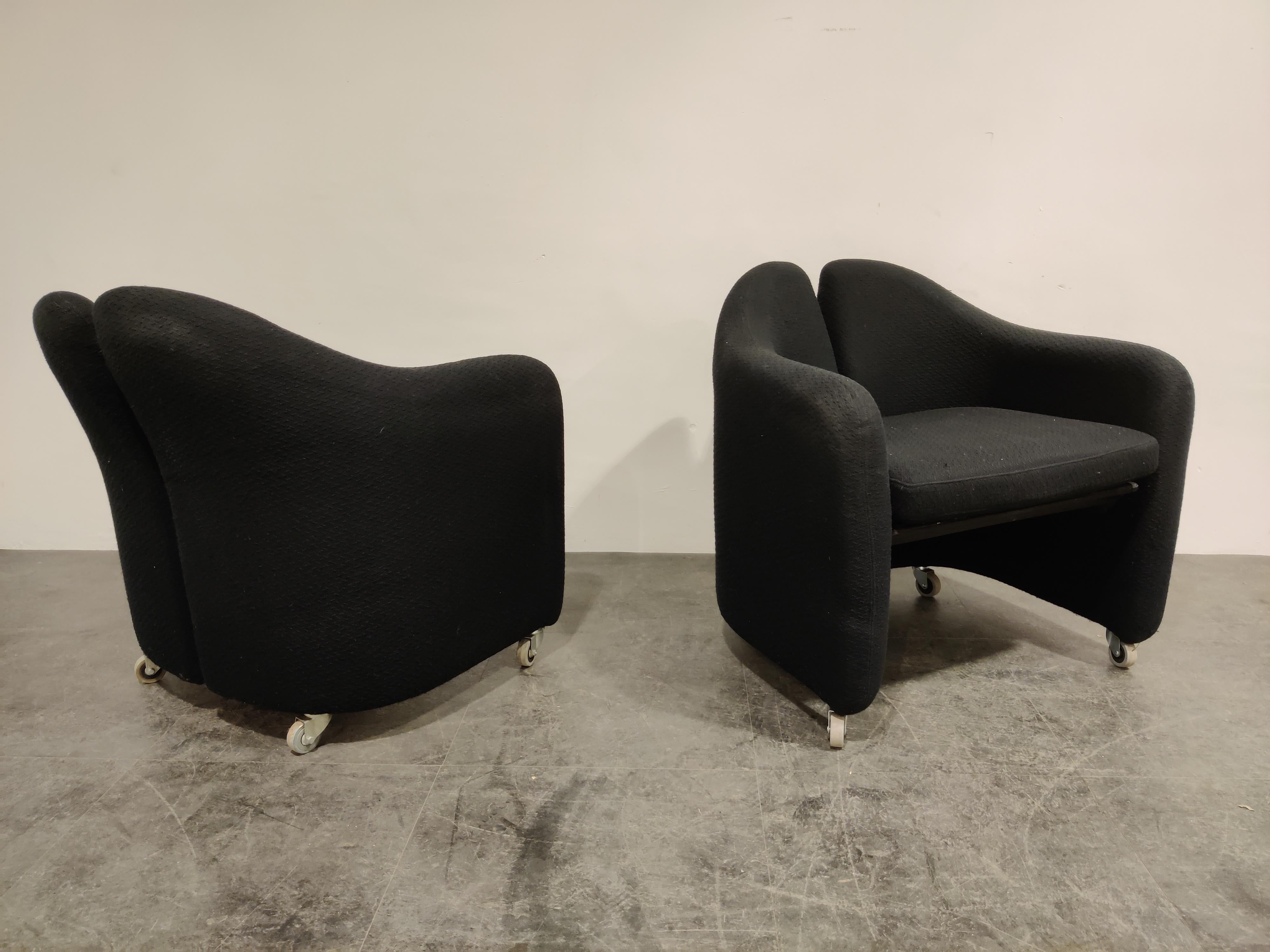 Pair of black fabric armchair designed by Eugenio Gerlio for Tecno, Italy.

These beautiful 'split back' armchairs sit very comfortable.

Good condition, missing a few strings underneath the seat, not influence on seating or